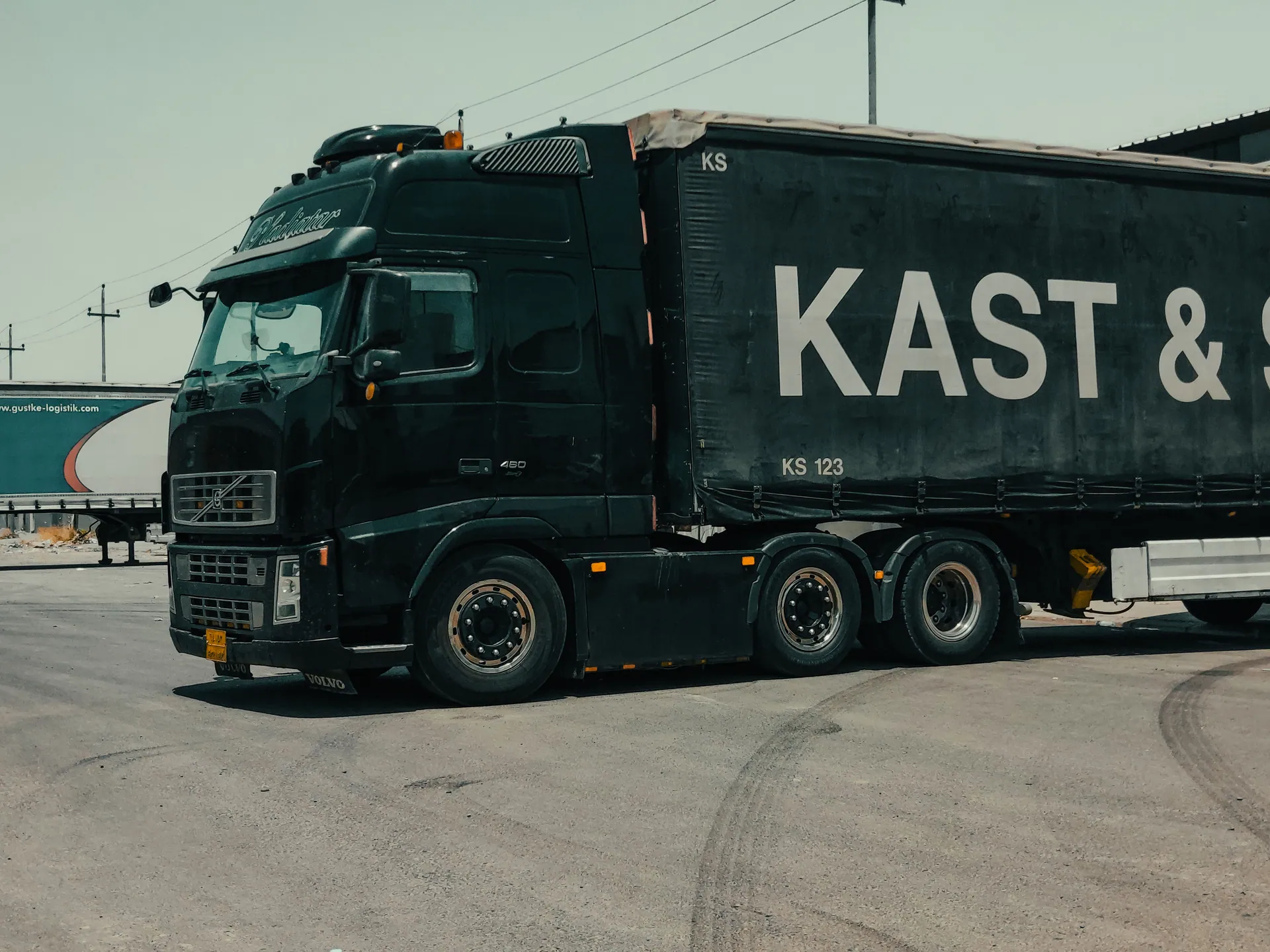 A large industrial truck parked in an urban setting, showcasing transportation industry visuals.