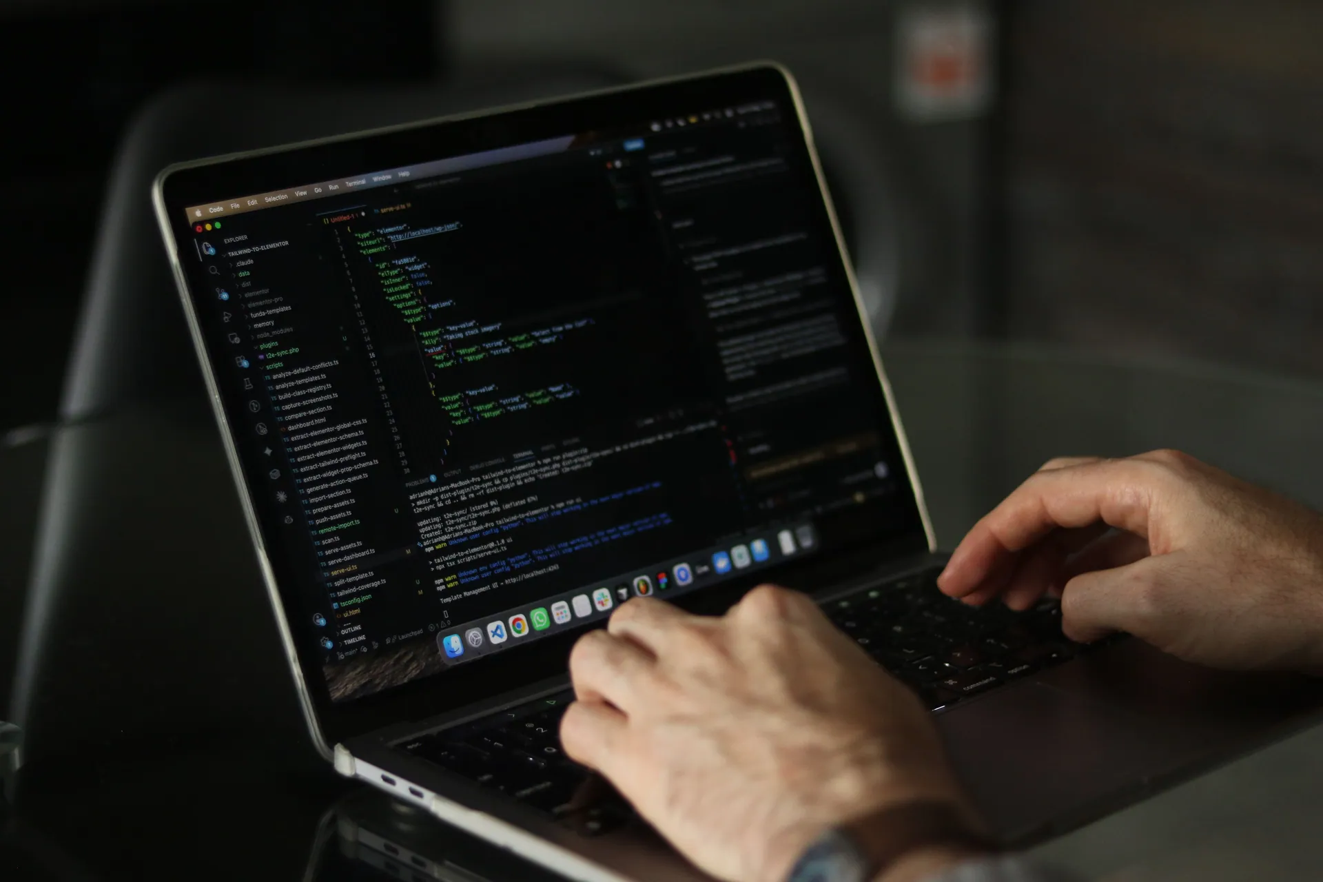 Close-up of hands coding on a laptop, focusing on programming productivity.