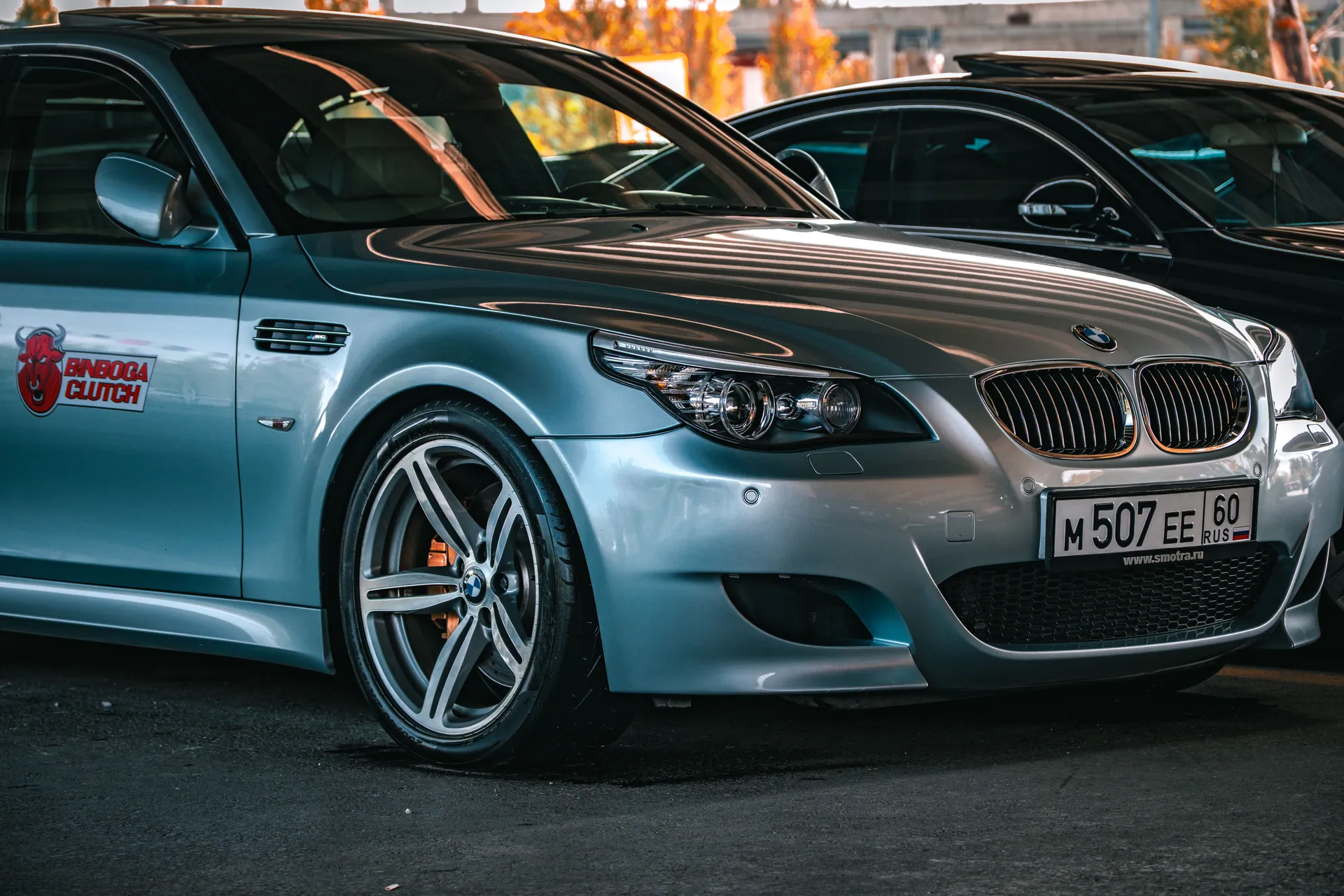 A stylish silver BMW parked in an indoor garage in Ankara, Türkiye, with custom decals and alloy wheels.