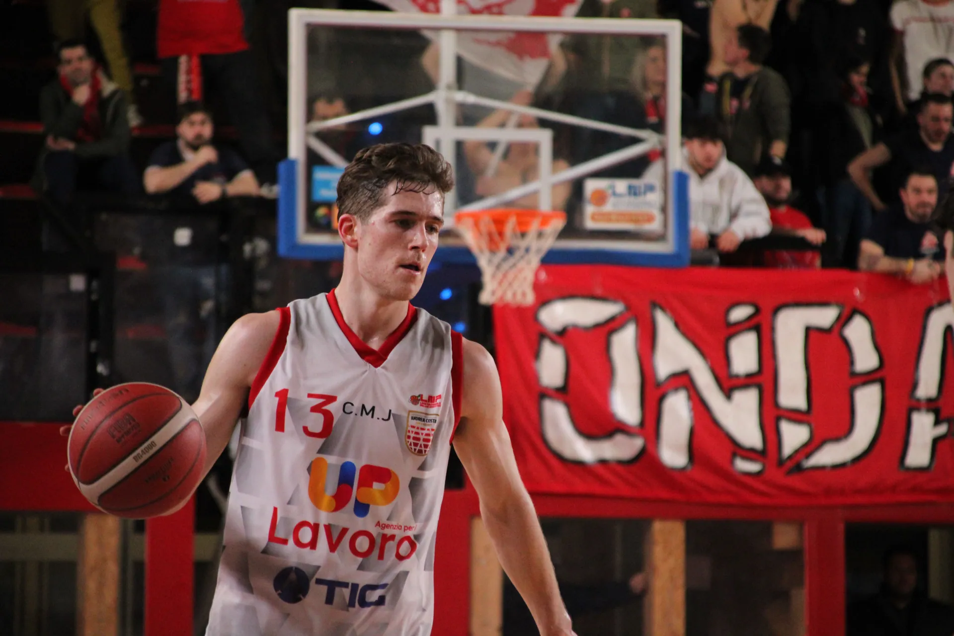 Action-packed basketball game captured in Imola, showcasing a focused player mid-game.