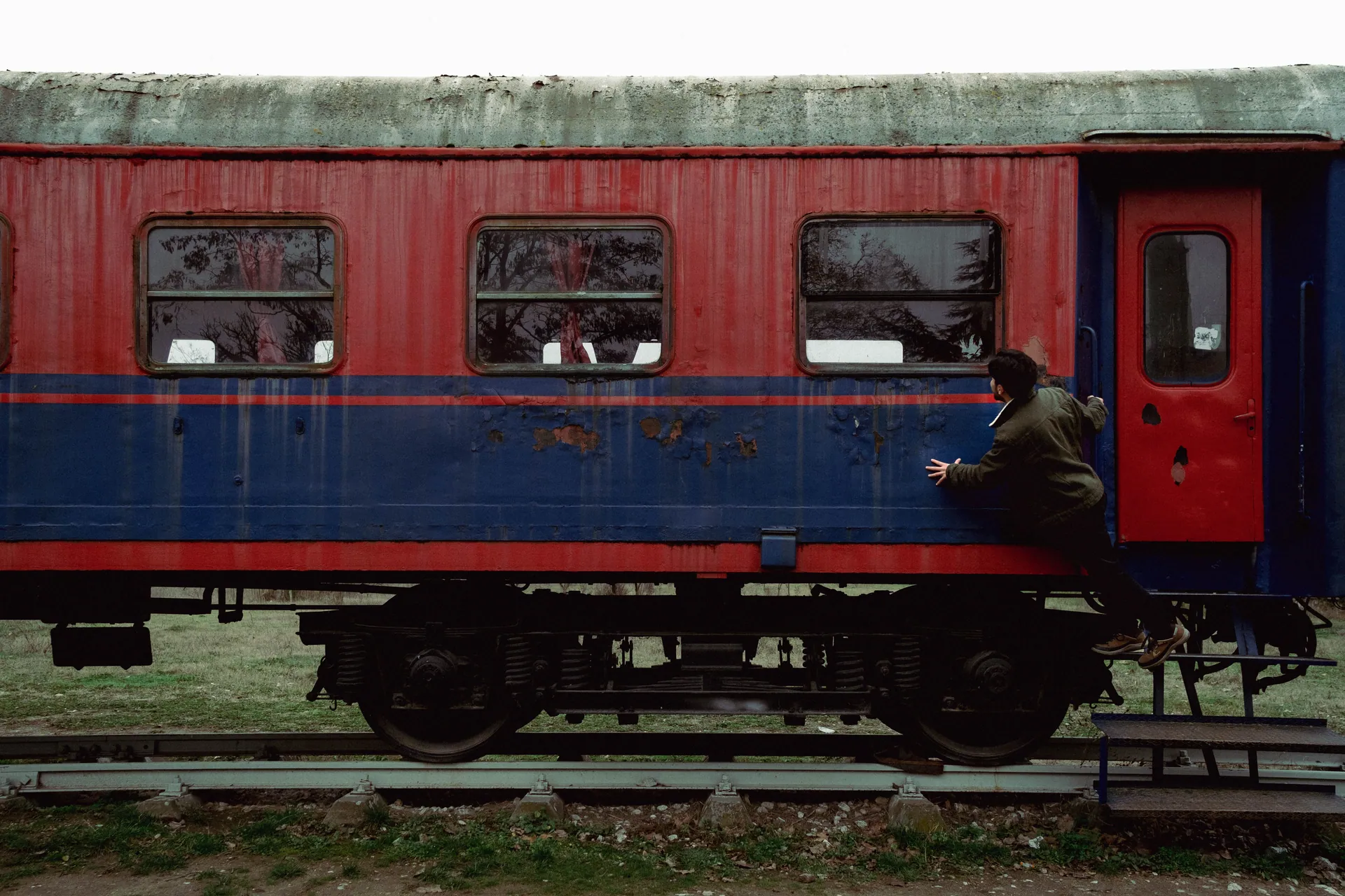 Vintage train carriage in Karaağaç, Edirne, Türkiye with person exploring.