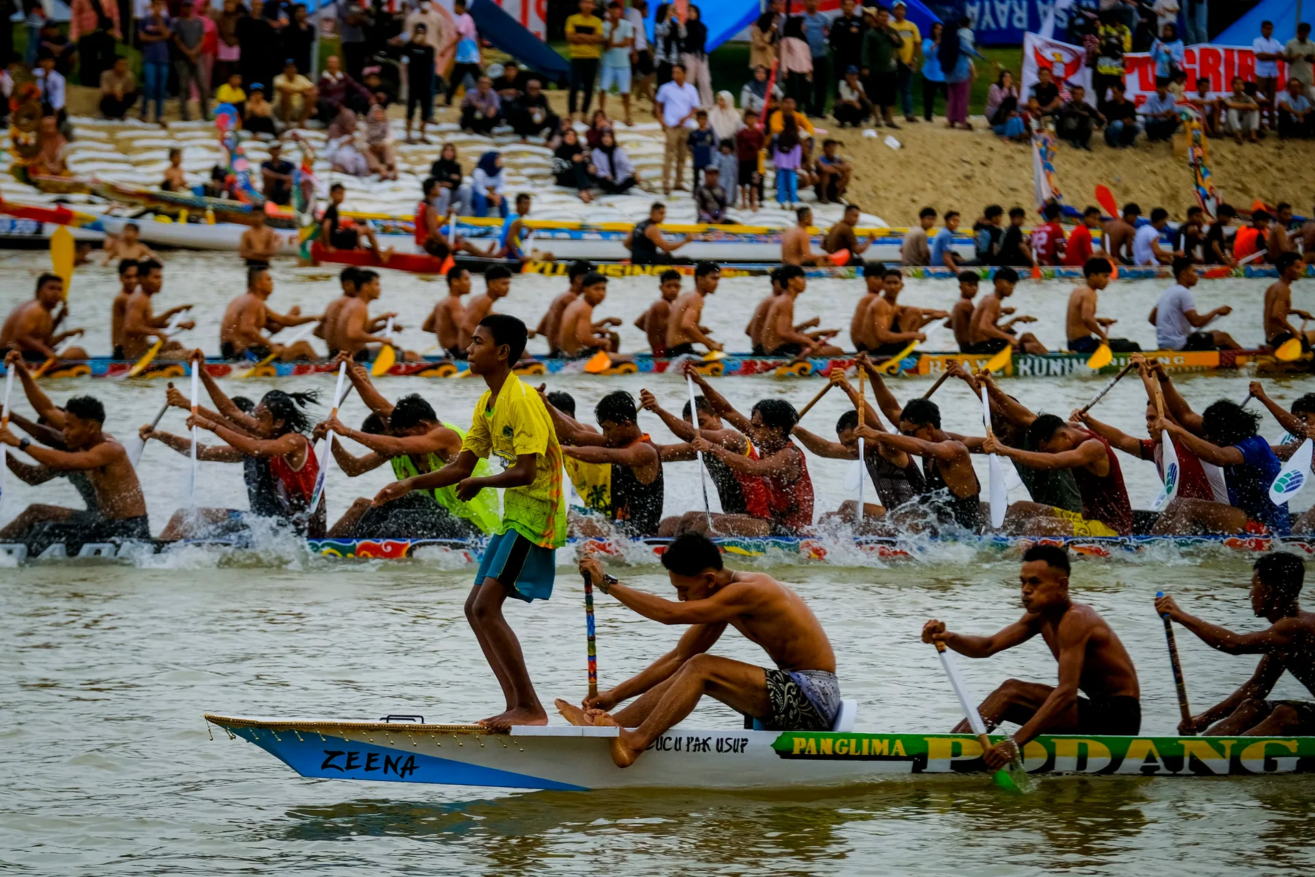 Energetic dragon boat race during a vibrant festival in Riau, showcasing teamwork and endurance.