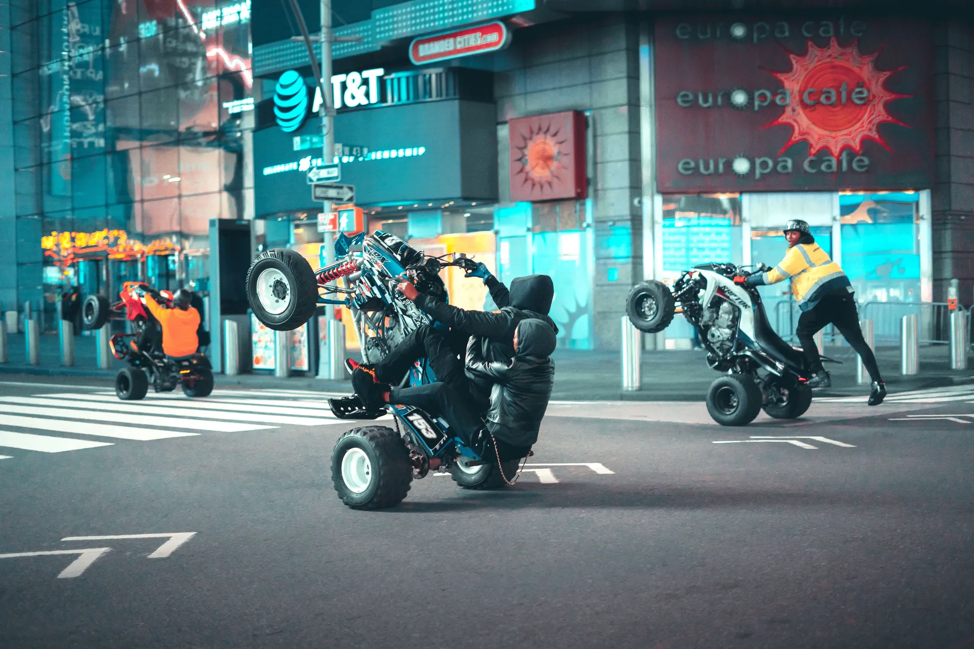 ATV stunt riders perform jaw-dropping tricks on New York City streets at night.