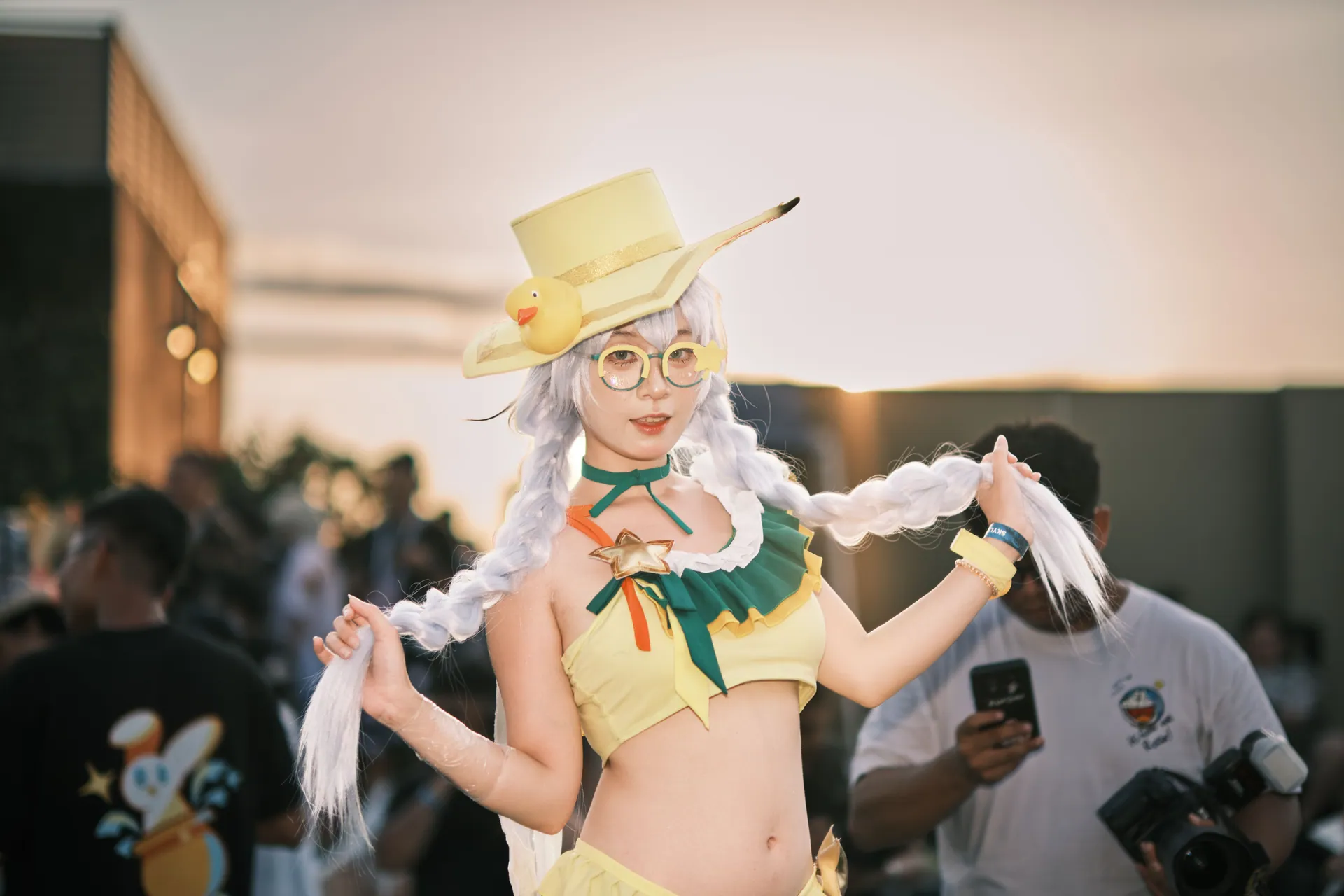 Vibrant cosplay character featuring a woman in a yellow costume at an outdoor event.
