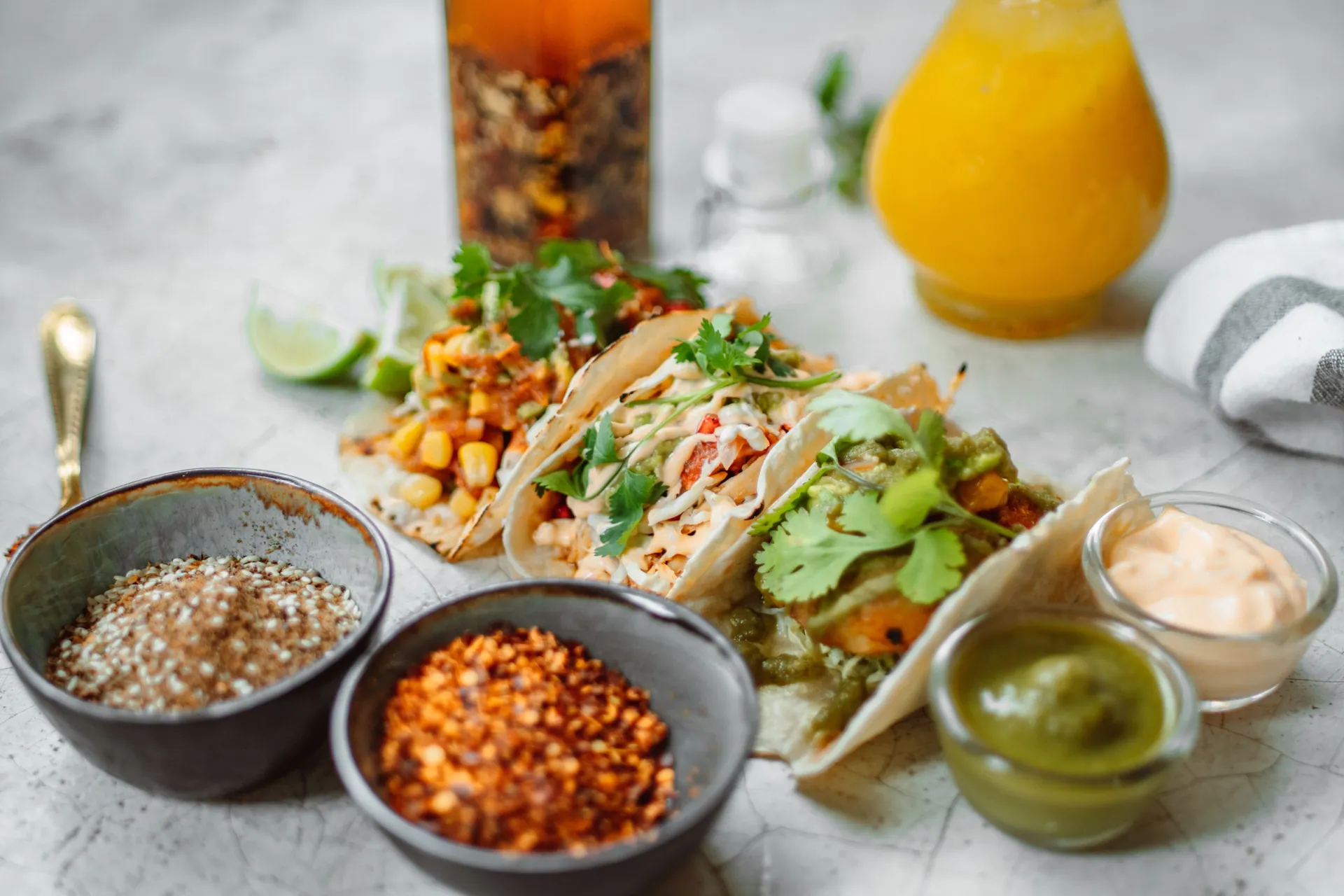 Close-up of Mexican tacos with diverse fillings, spices, and sauces, perfect for food lovers.