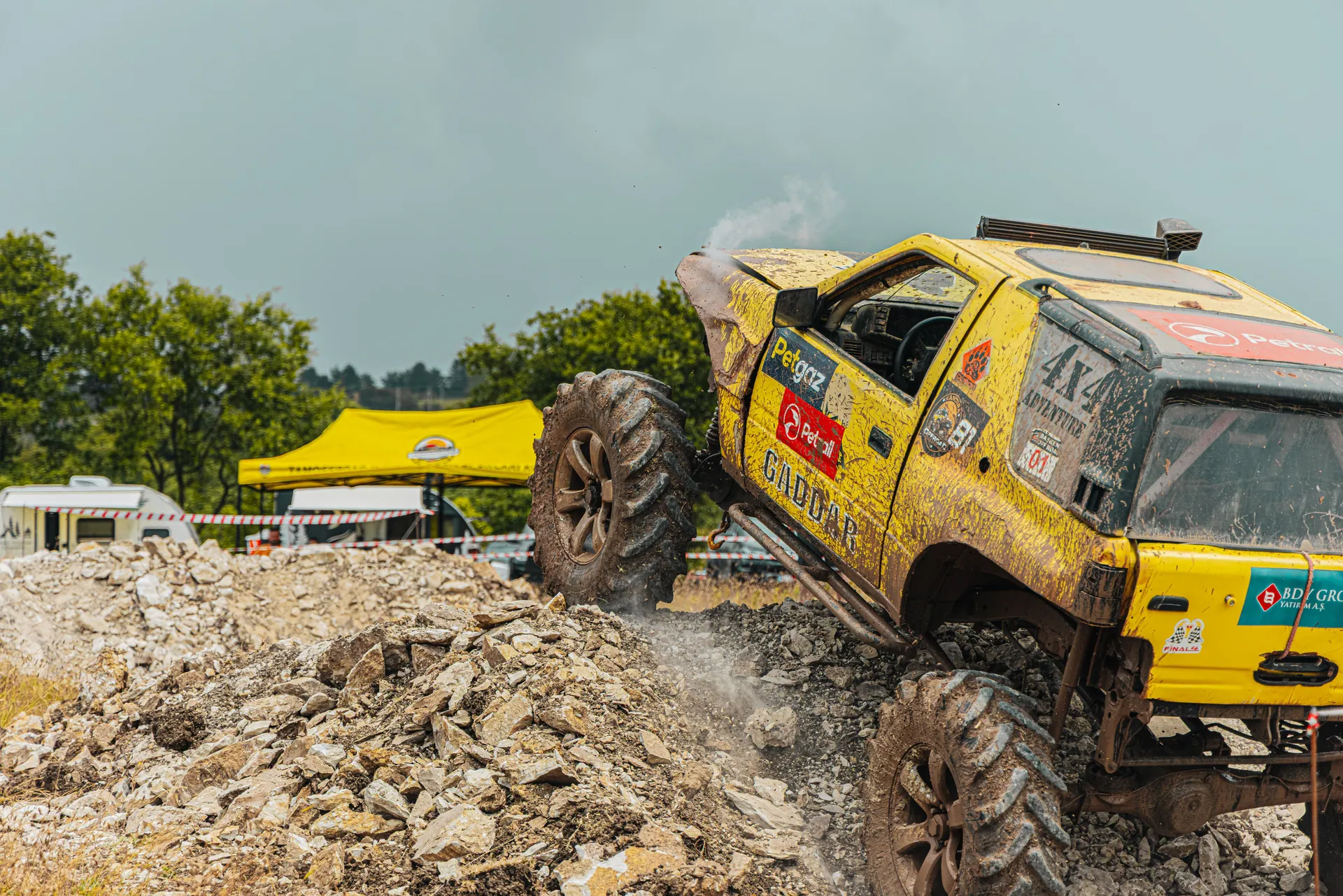 Dynamic offroad car race conquering rocky terrain with adrenaline and excitement.