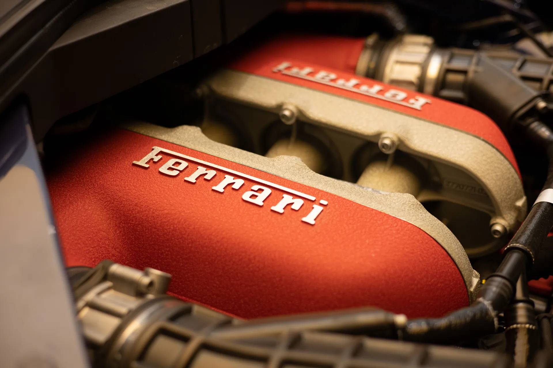 Detailed close-up of a Ferrari engine showcasing luxury and performance.