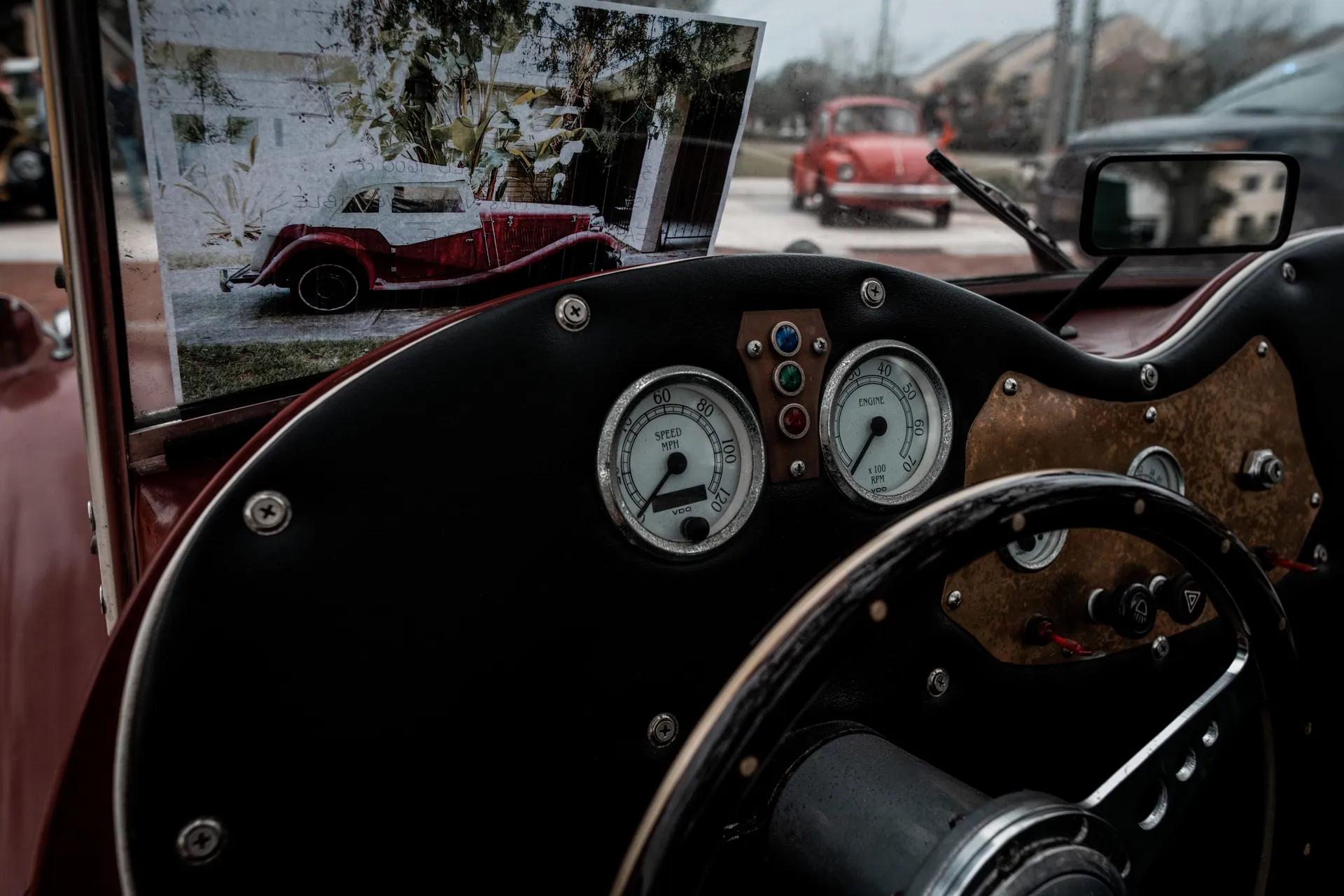 Close-up of a vintage car's cockpit featuring a classic speedometer and retro design elements.