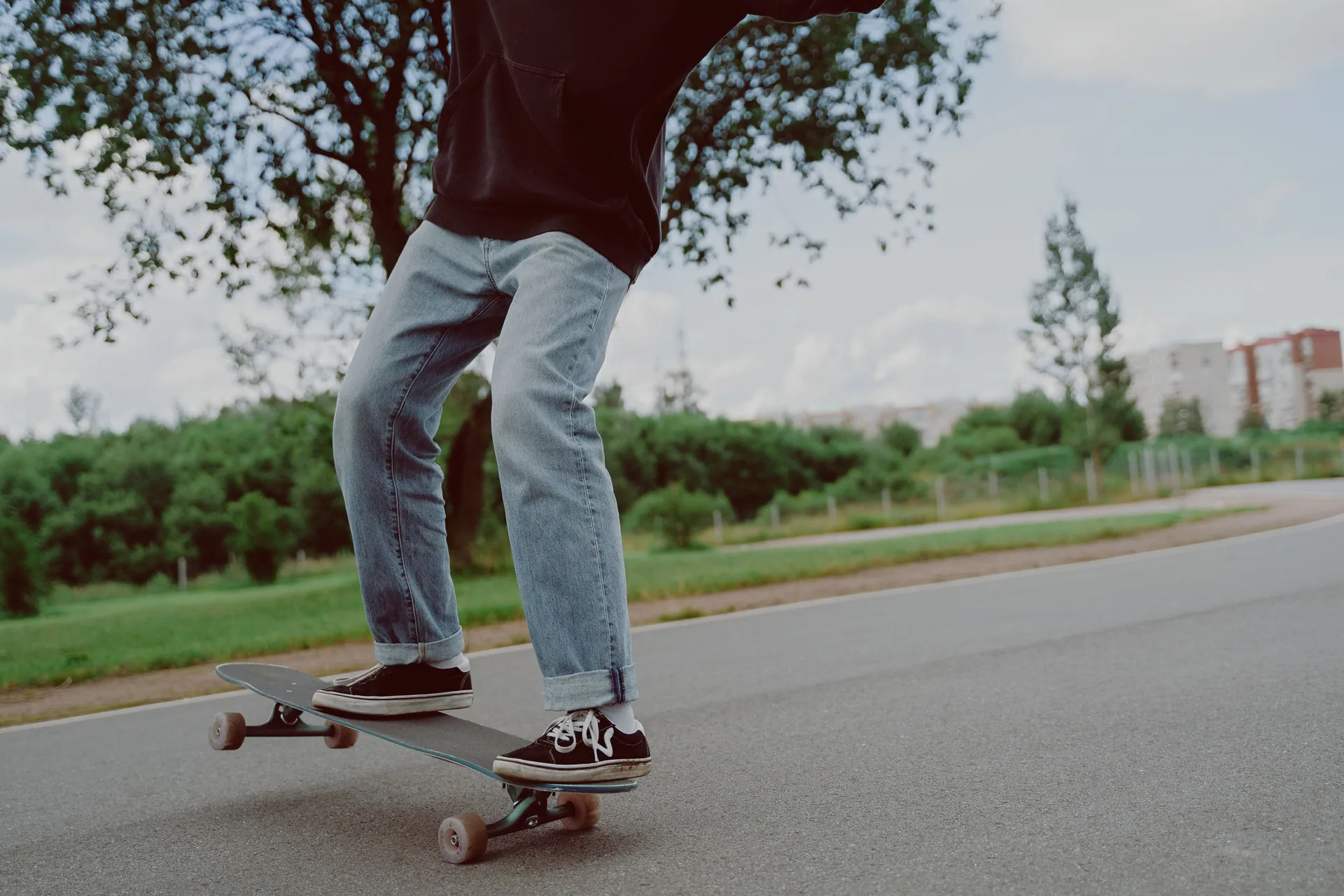 Young person mastering skateboarding moves in a park setting.