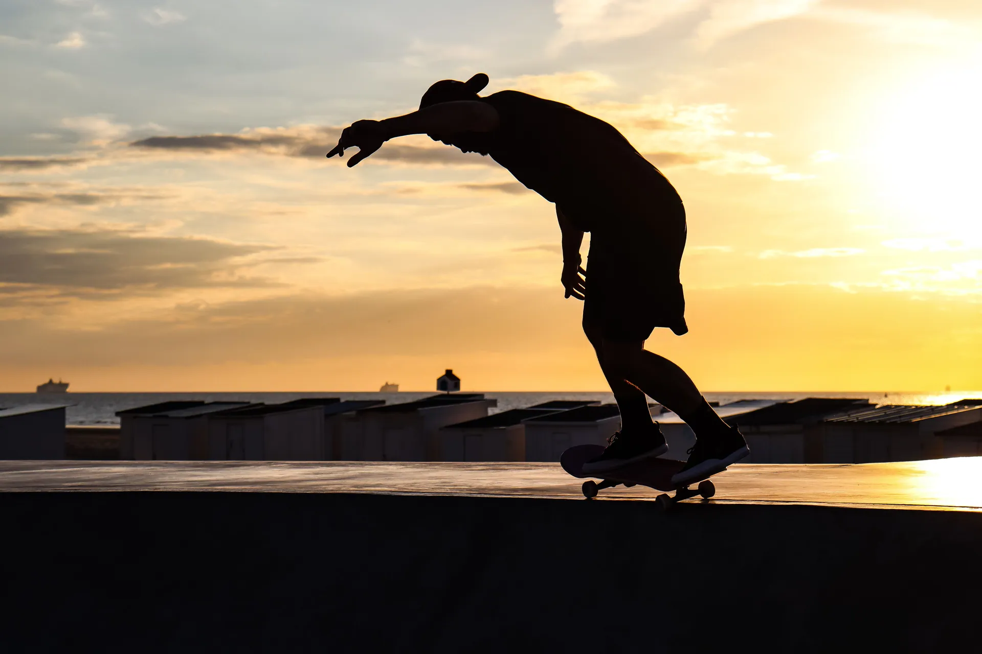 Dynamic silhouette of a skateboarder at sunset in Calais skatepark. Perfect lighting and action shot.