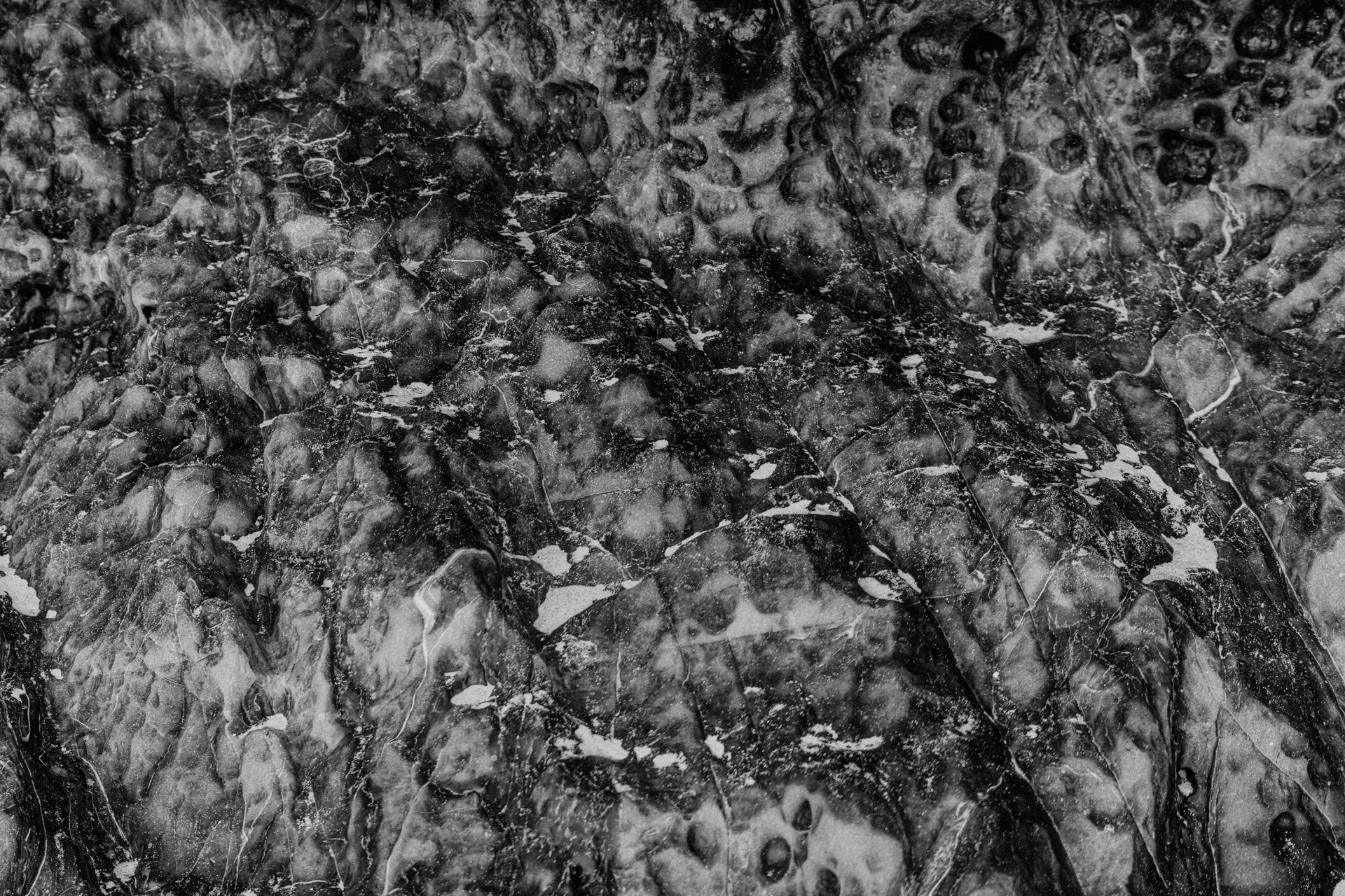 Close-up of a black and white marble texture showcasing natural intricate patterns.