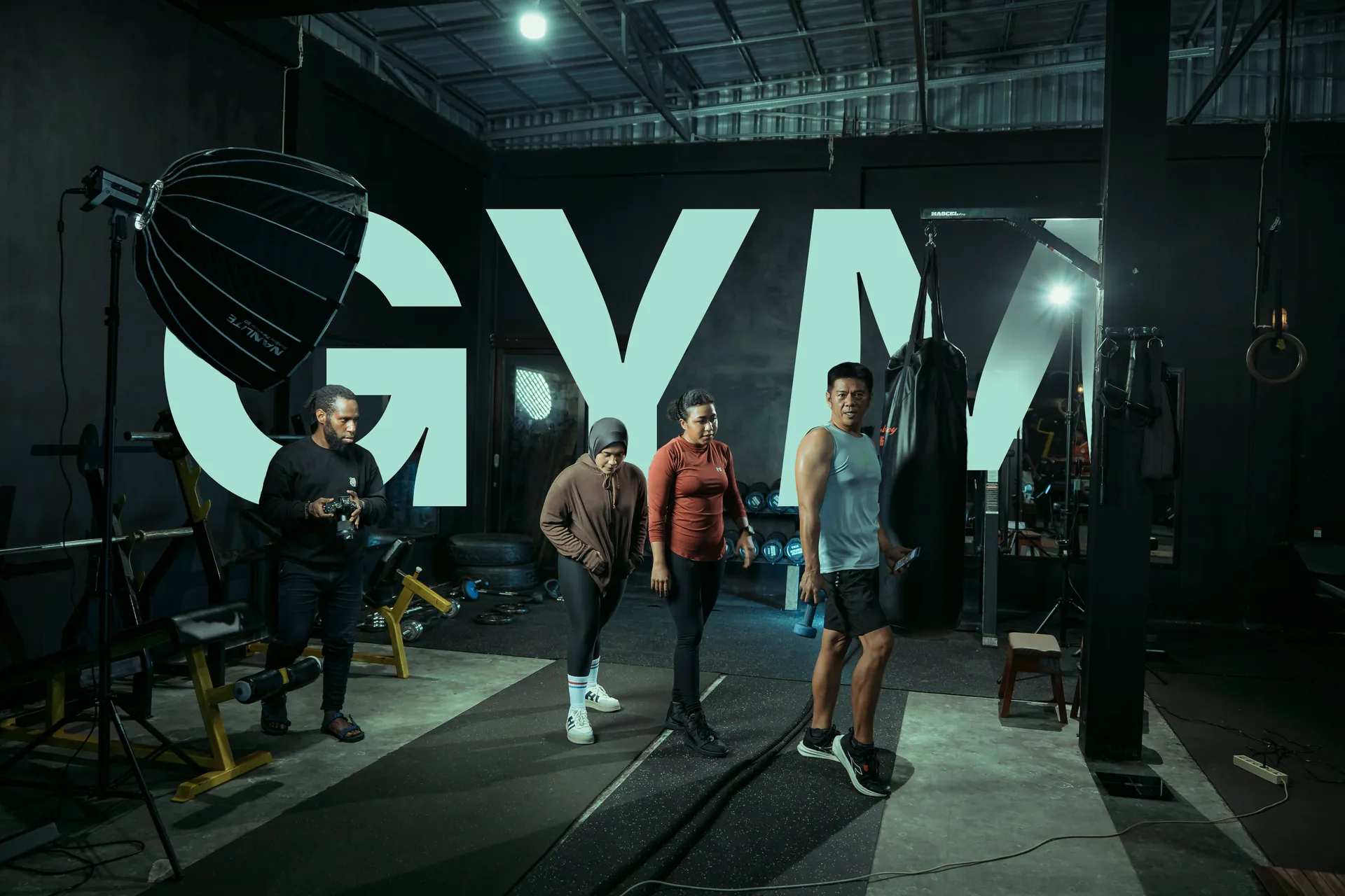Four people in a gym setting engaged with fitness equipment, showcasing modern athleticism.