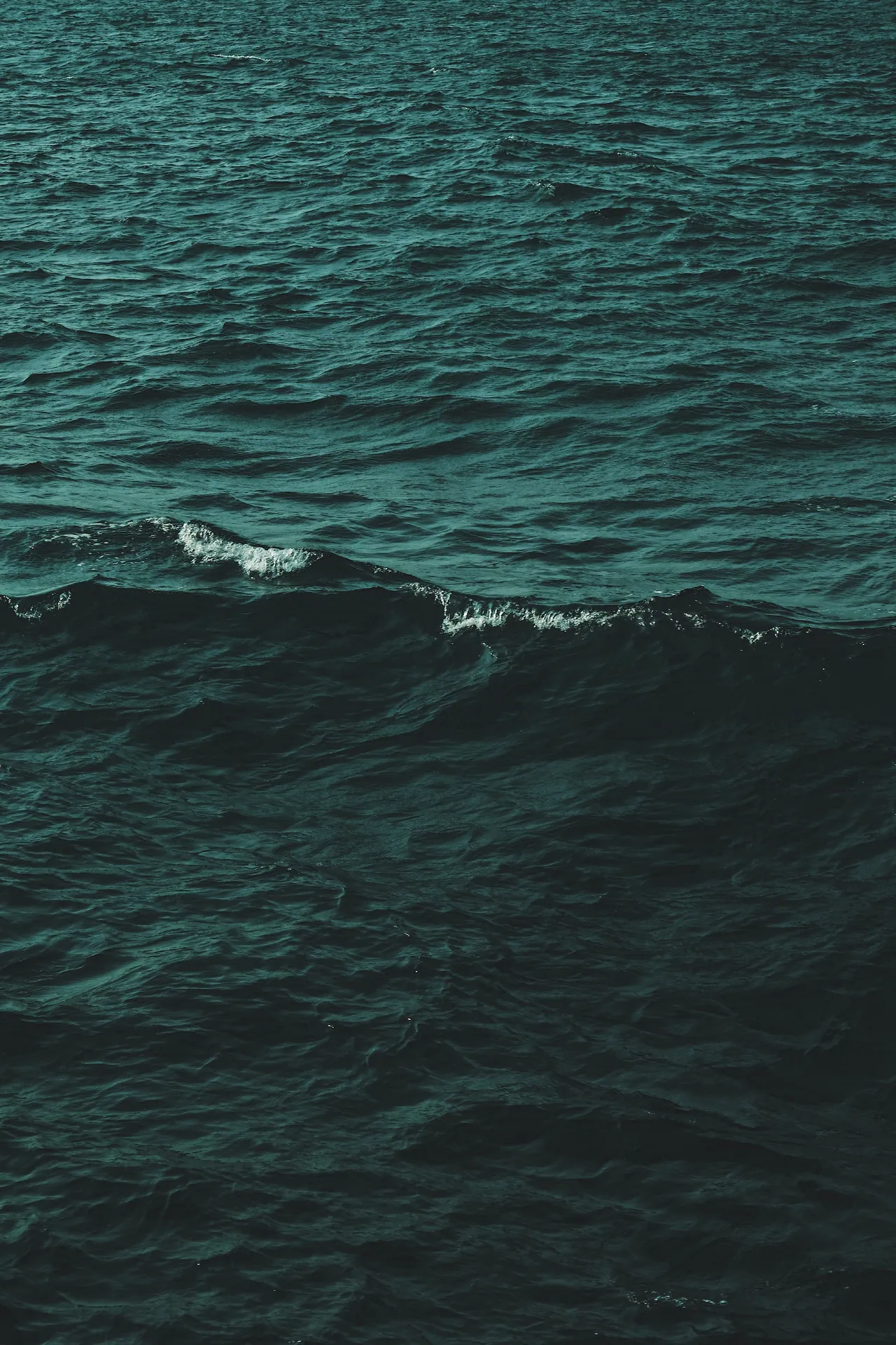 Captivating view of ocean waves near Chonburi, Thailand, showcasing deep blue water and natural movement.