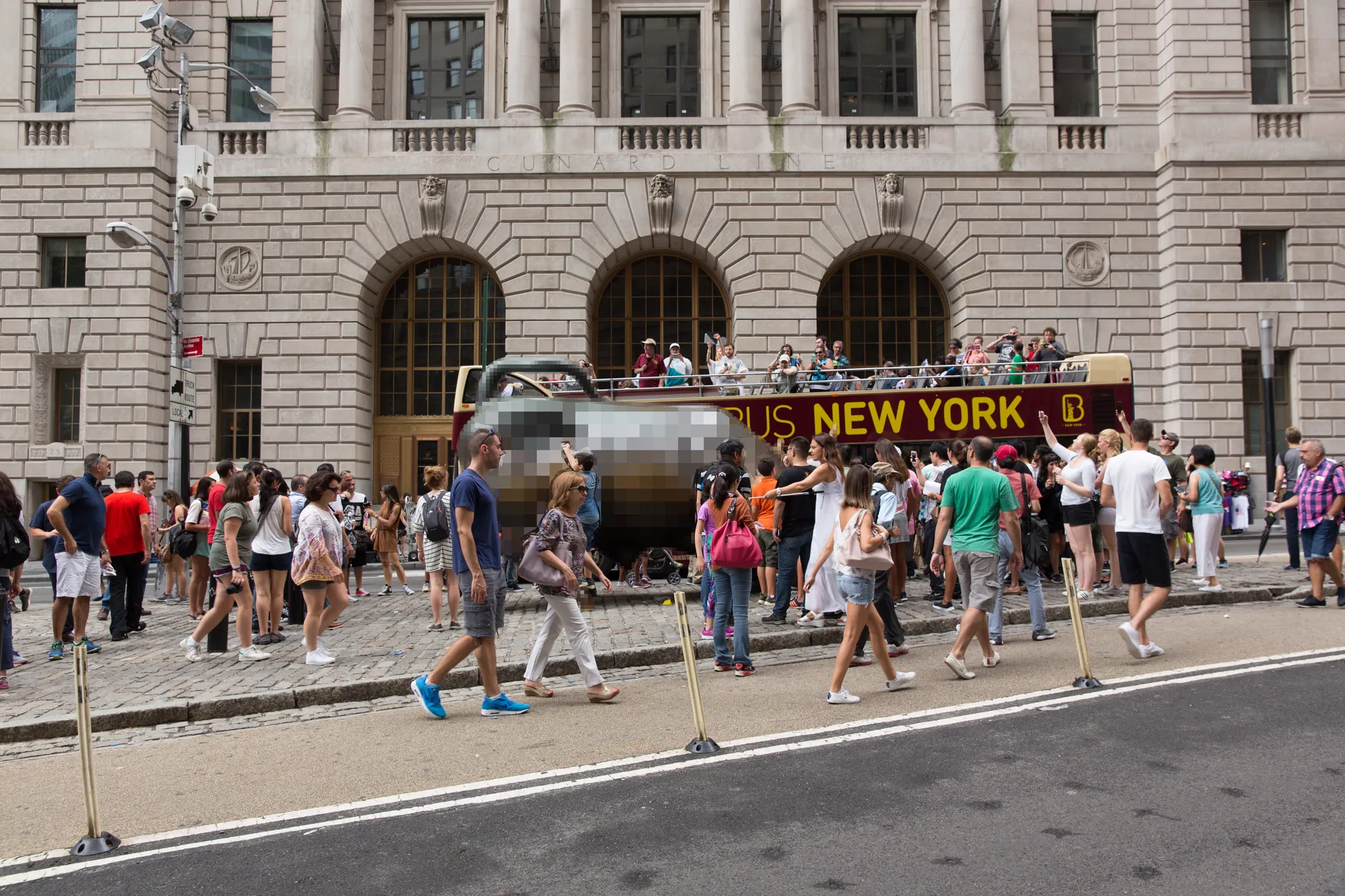 Lamp post and surveillance cameras and tourists making selfies of the Charging Bull derived from 20230102023120!Charging Bull (28919670730) (pixelated)
