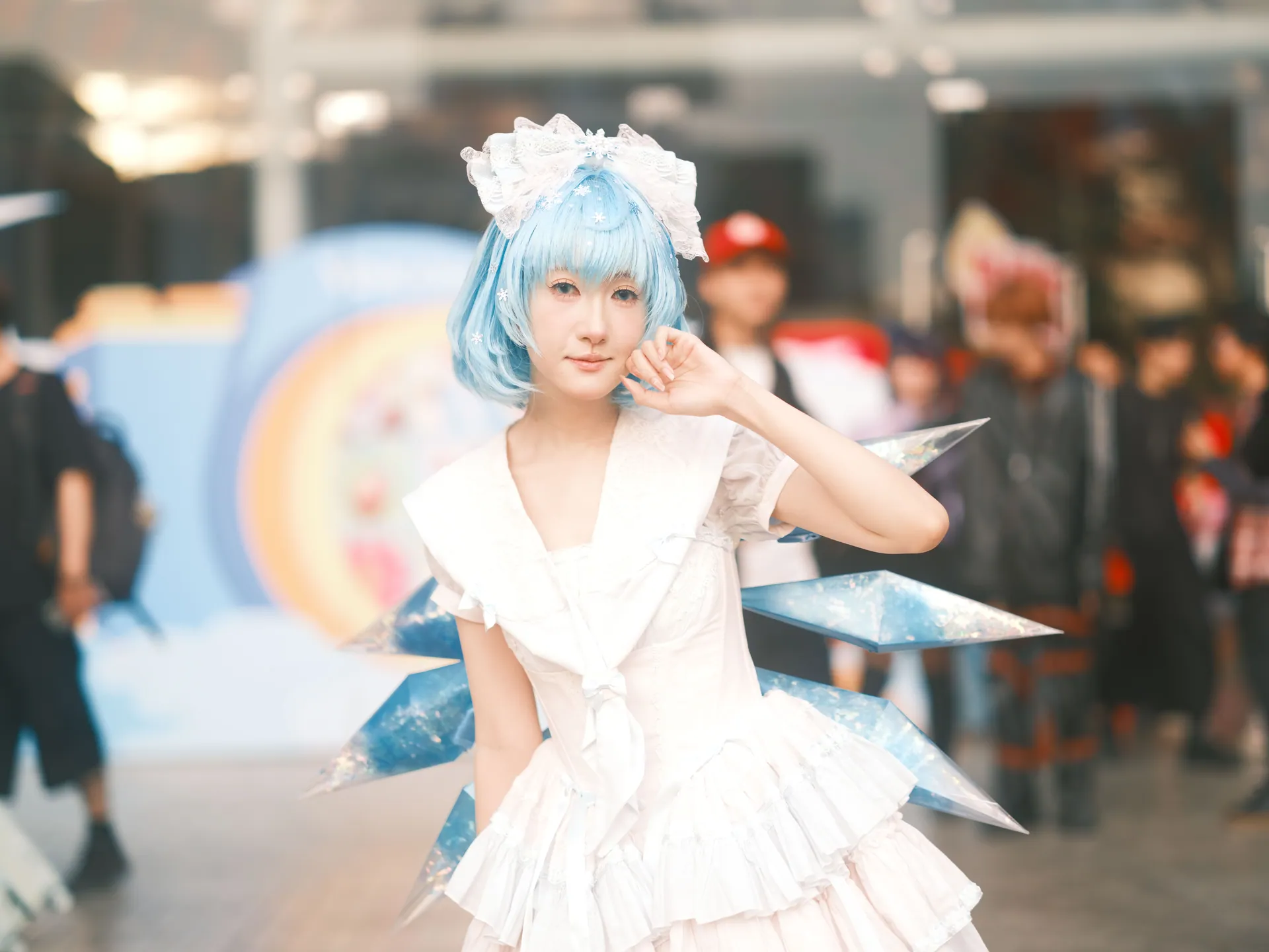 Woman in blue-haired costume at a vibrant cosplay event in Vietnam.