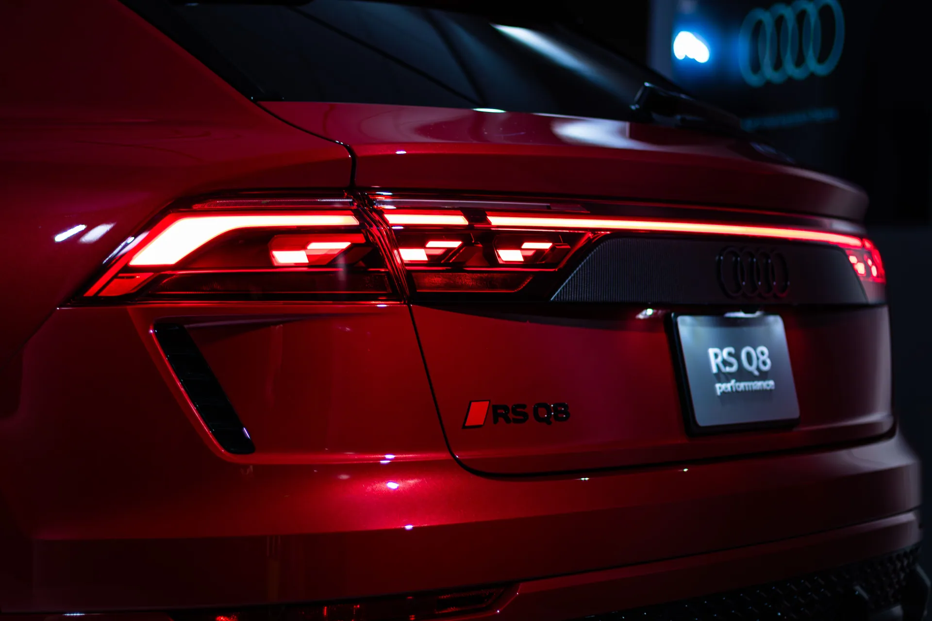 Red Audi RS Q8 tail light and branding in Toronto studio setting.