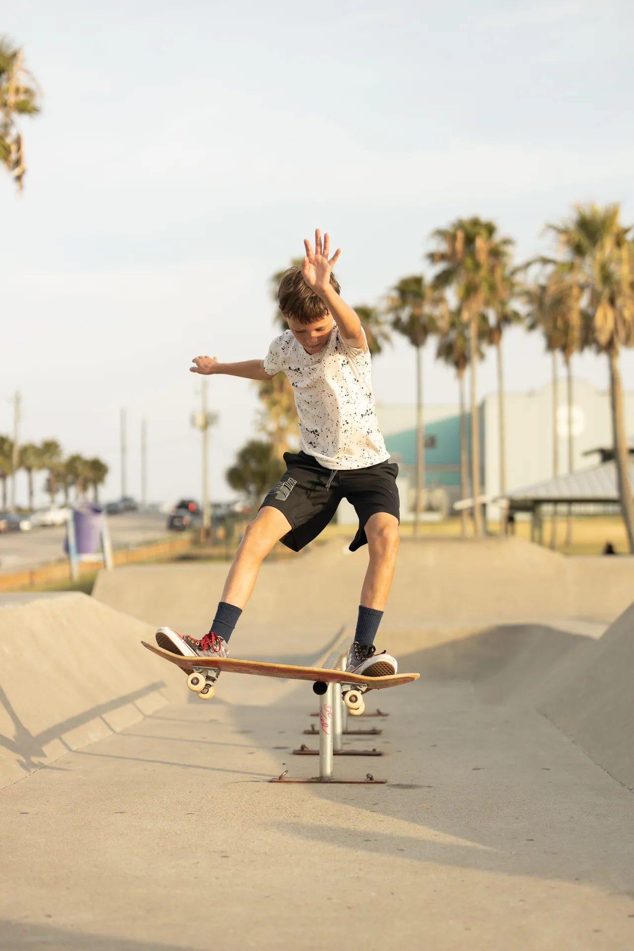 A young skateboarder skillfully performs a trick on a sunny day at a skate park in Texas. Perfect for active lifestyle imagery.