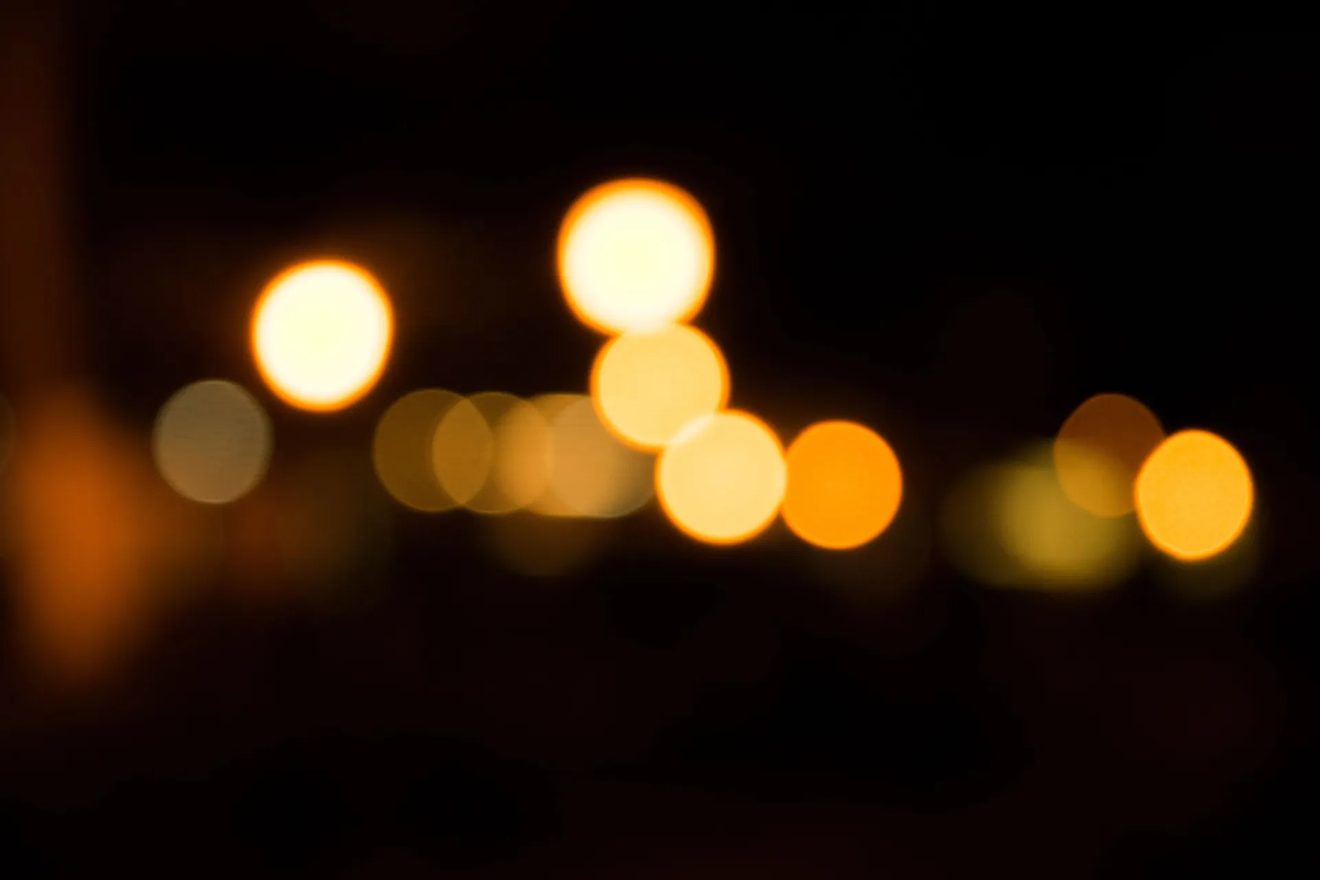 Blurred golden bokeh lights create a warm festive atmosphere on a dark background.