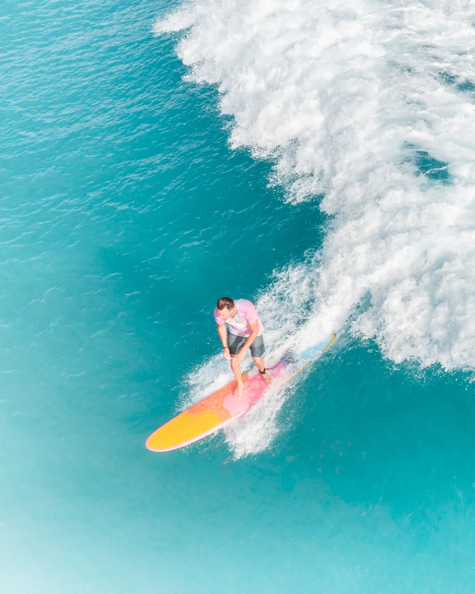 A vibrant shot of a surfer skillfully riding a wave on a sunny day.