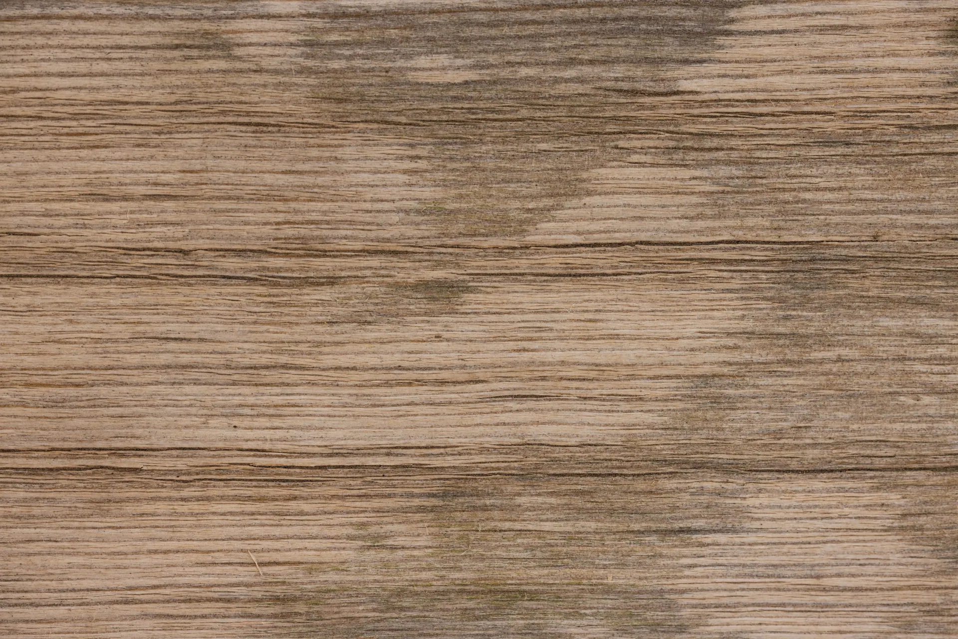 Close-up of aged wooden surface with natural texture and stains.