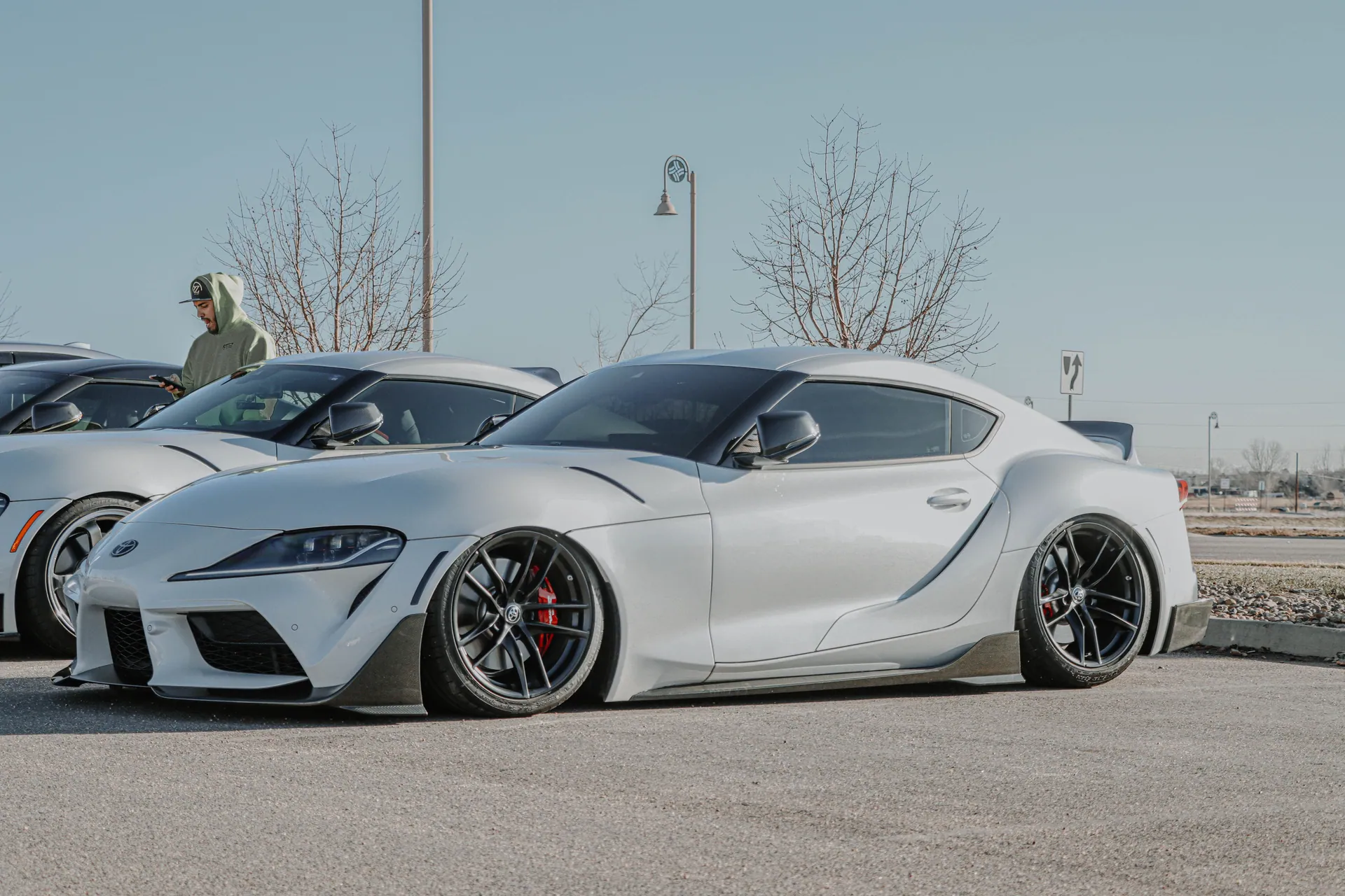 Sleek Toyota Supra showcased outdoors at a Denver car meet with pristine details.