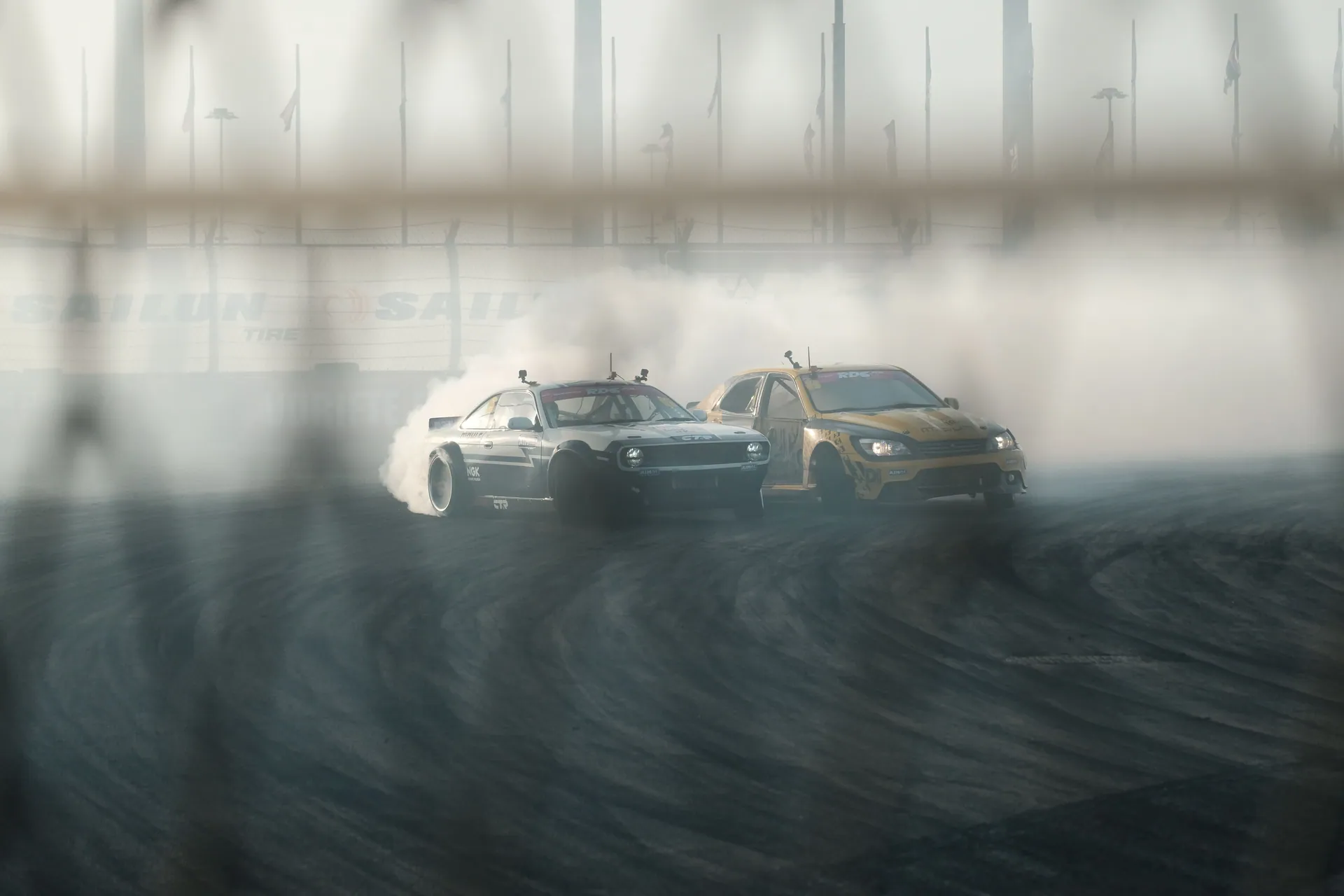 Thrilling car drift racing with smoke effects on a track. Dynamic action scene.