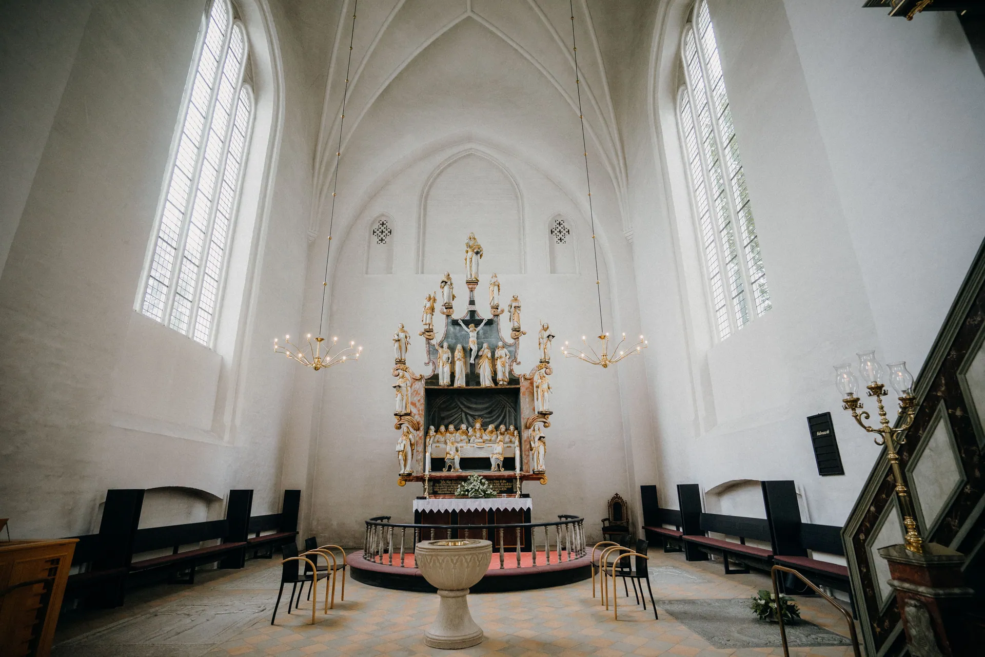 A beautifully captured church interior featuring an elaborate altar under high arched ceilings.