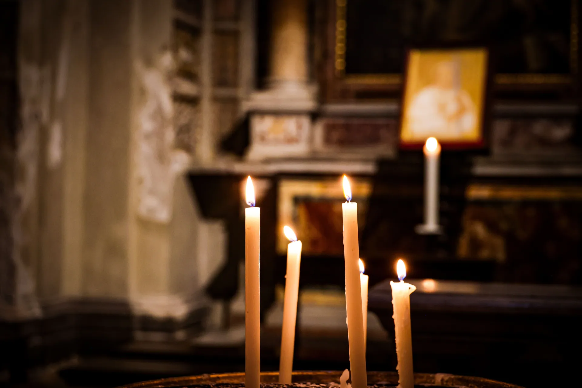 Warm candlelight illuminating a church interior, creating a peaceful, spiritual atmosphere.