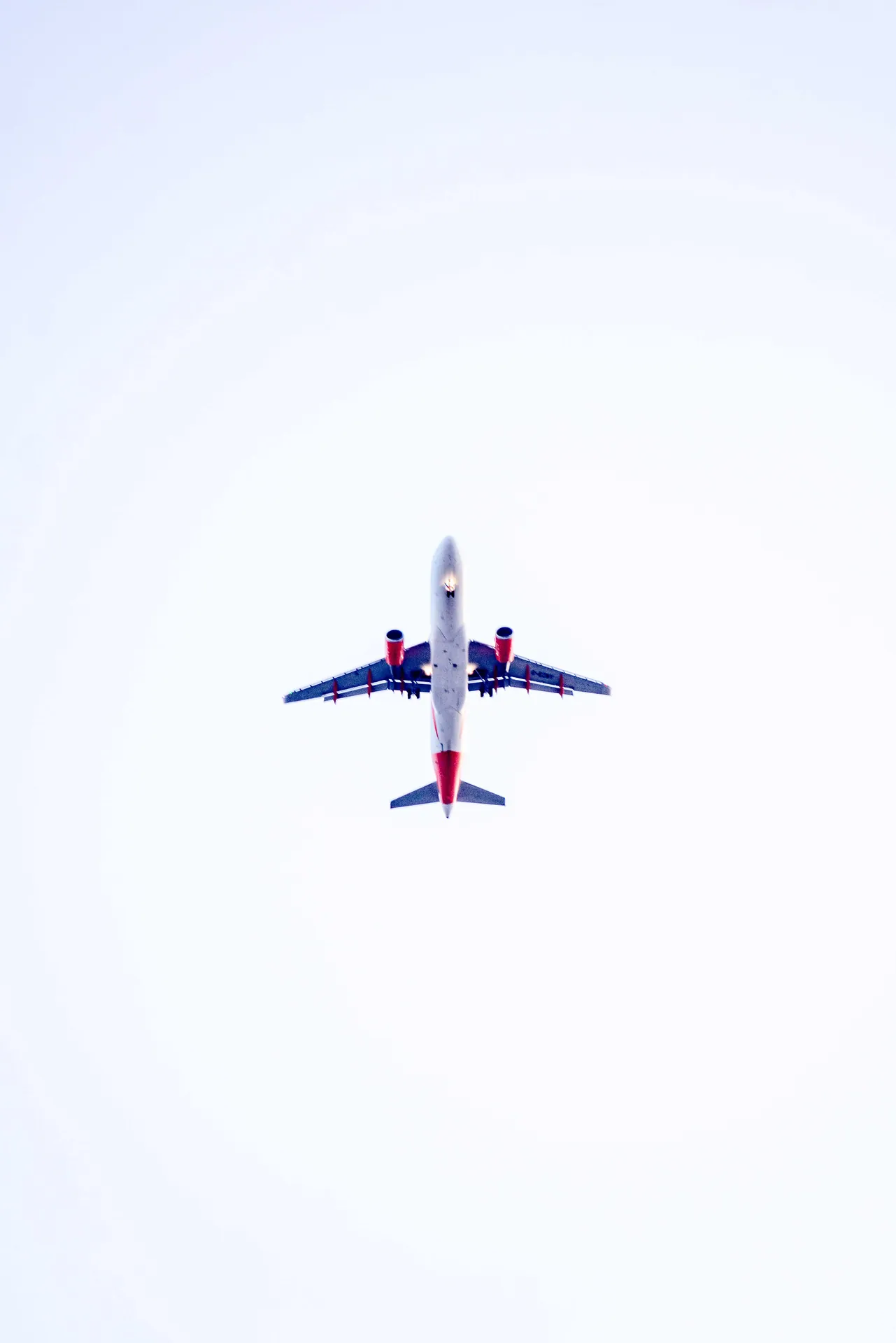 Low angle view of an airplane flying overhead, capturing the essence of aviation.