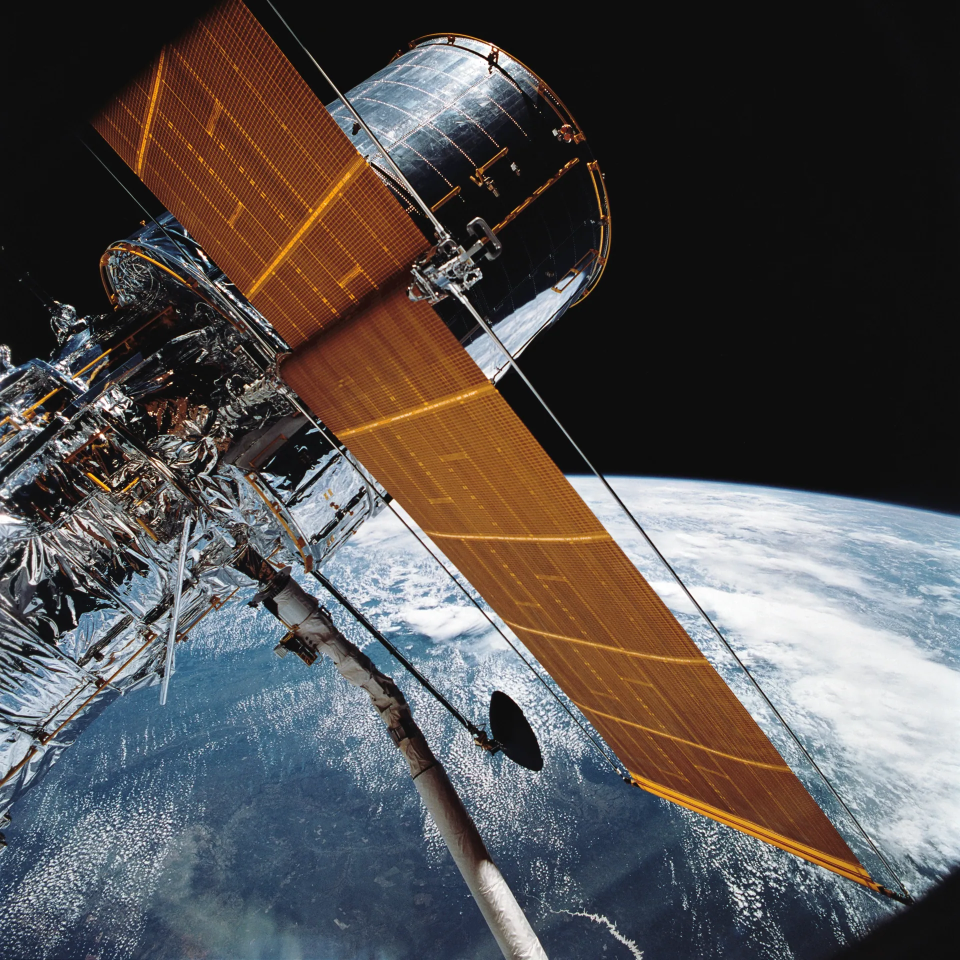 Hubble Space Telescope Grappled by Shuttle Arm