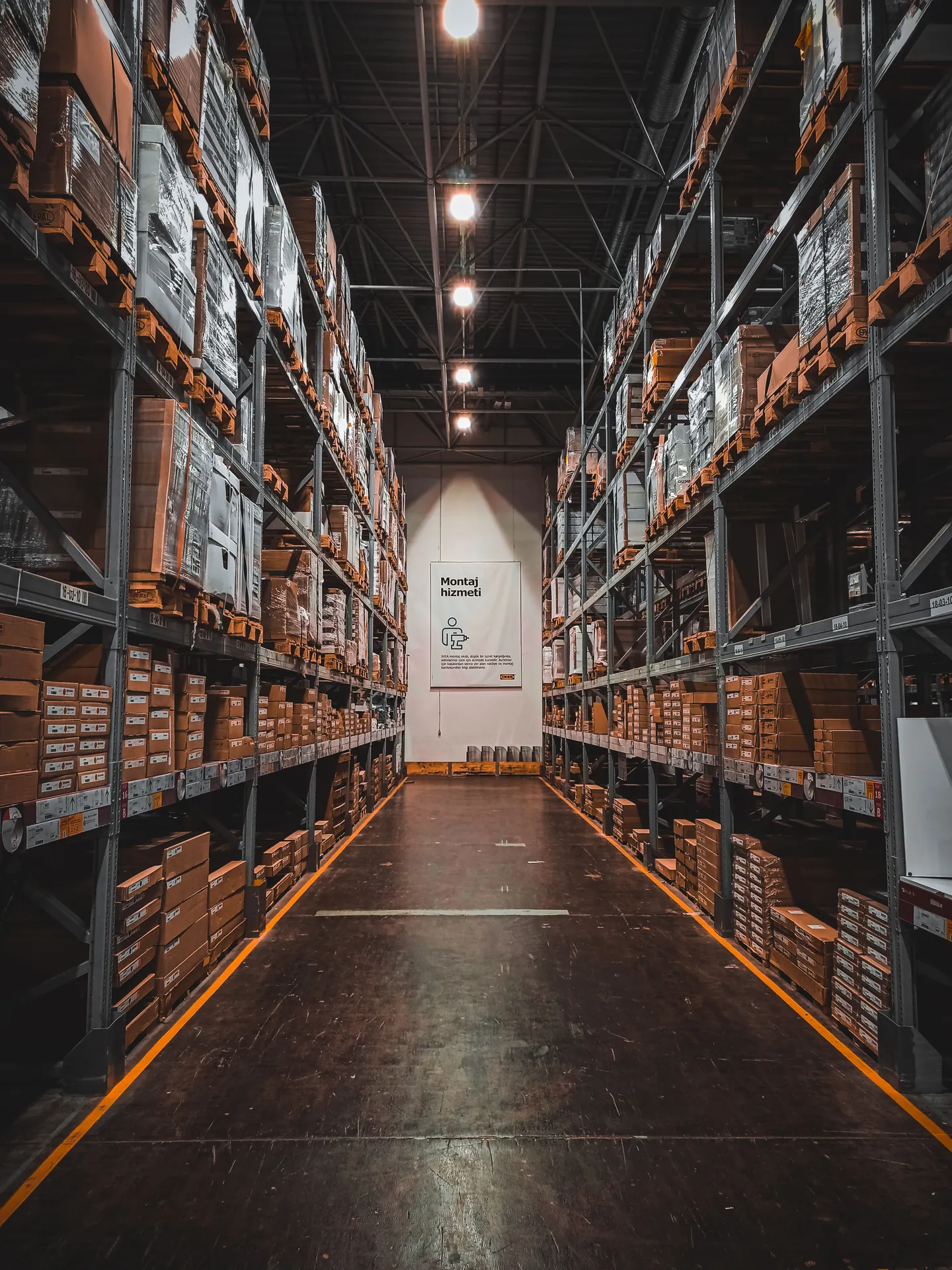 A well-organized warehouse aisle with stacks of goods on industrial storage racks, ensuring efficient logistics.