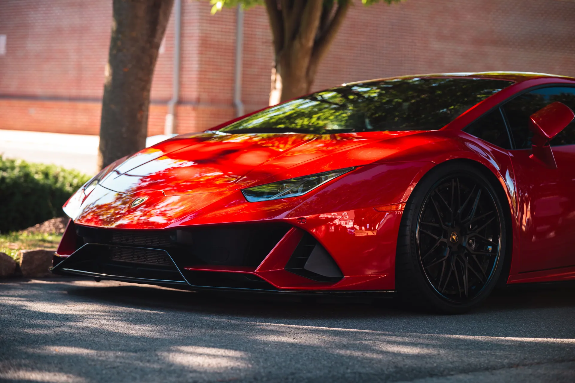 Vibrant red sports car parked outdoors, showcasing sleek design and modern elegance.