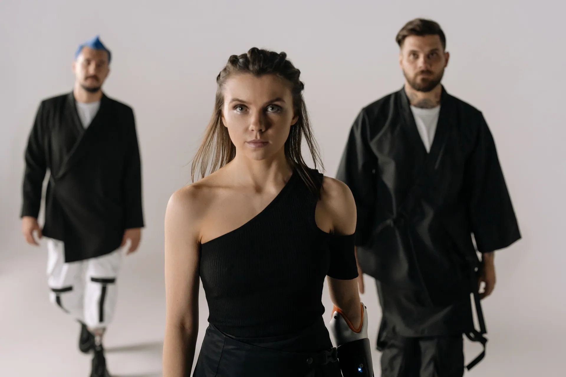 Diverse group showcasing fashion and prosthetic technology in a modern studio setting.