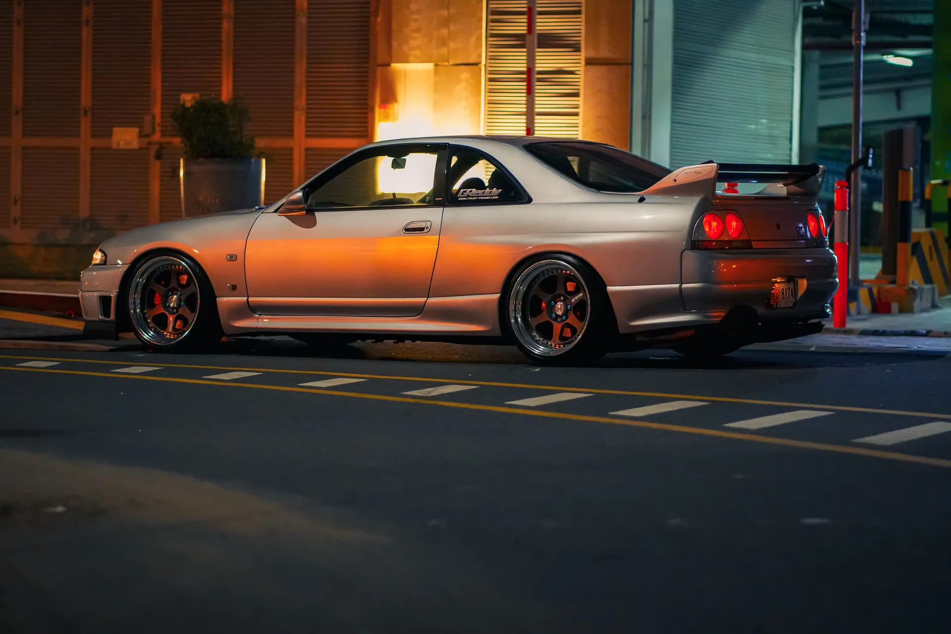 A custom Nissan GT-R parked on Dubai city streets at night, showcasing its sleek design and powerful presence.