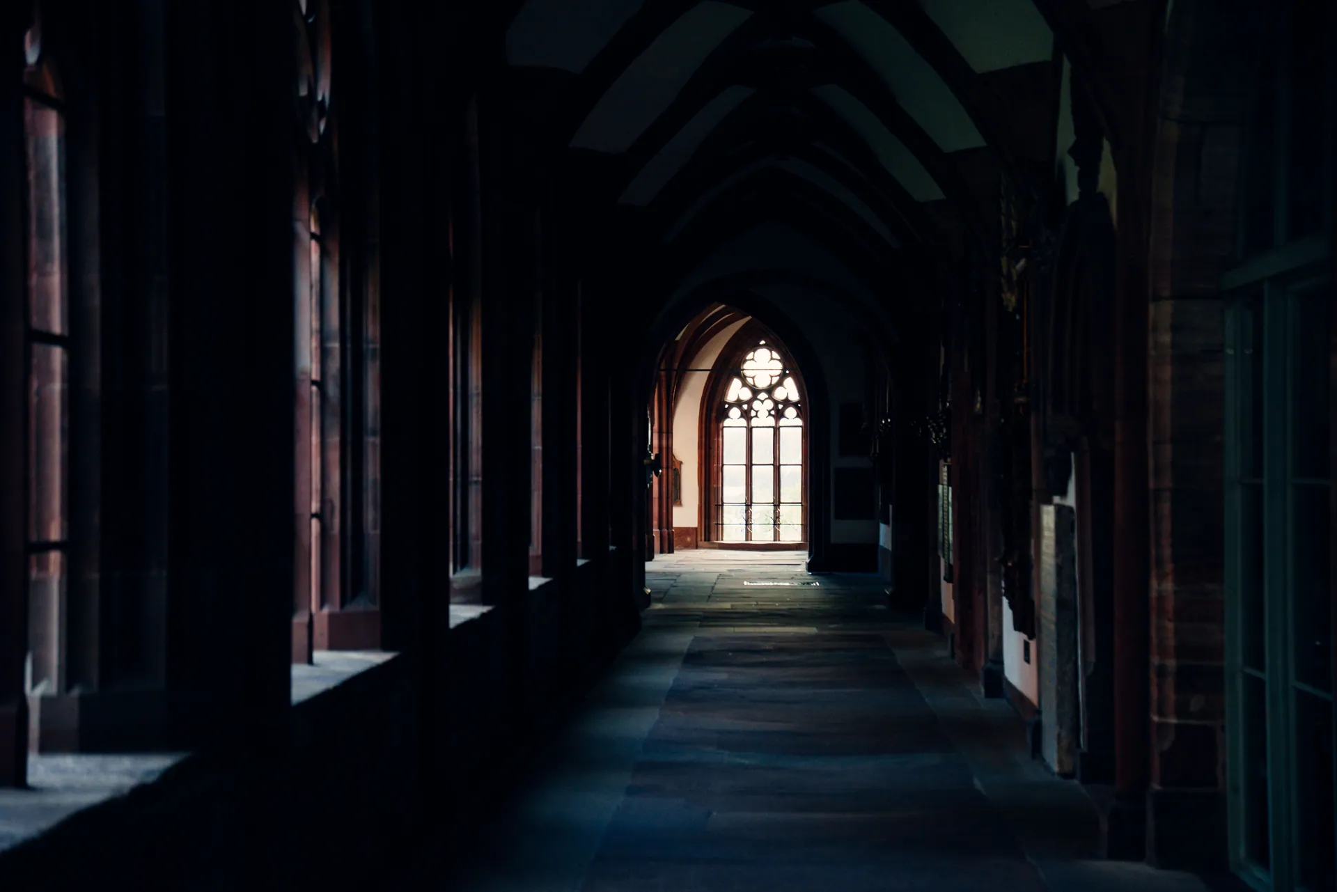 View of a historic gothic church corridor in Basel, showcasing architectural beauty.