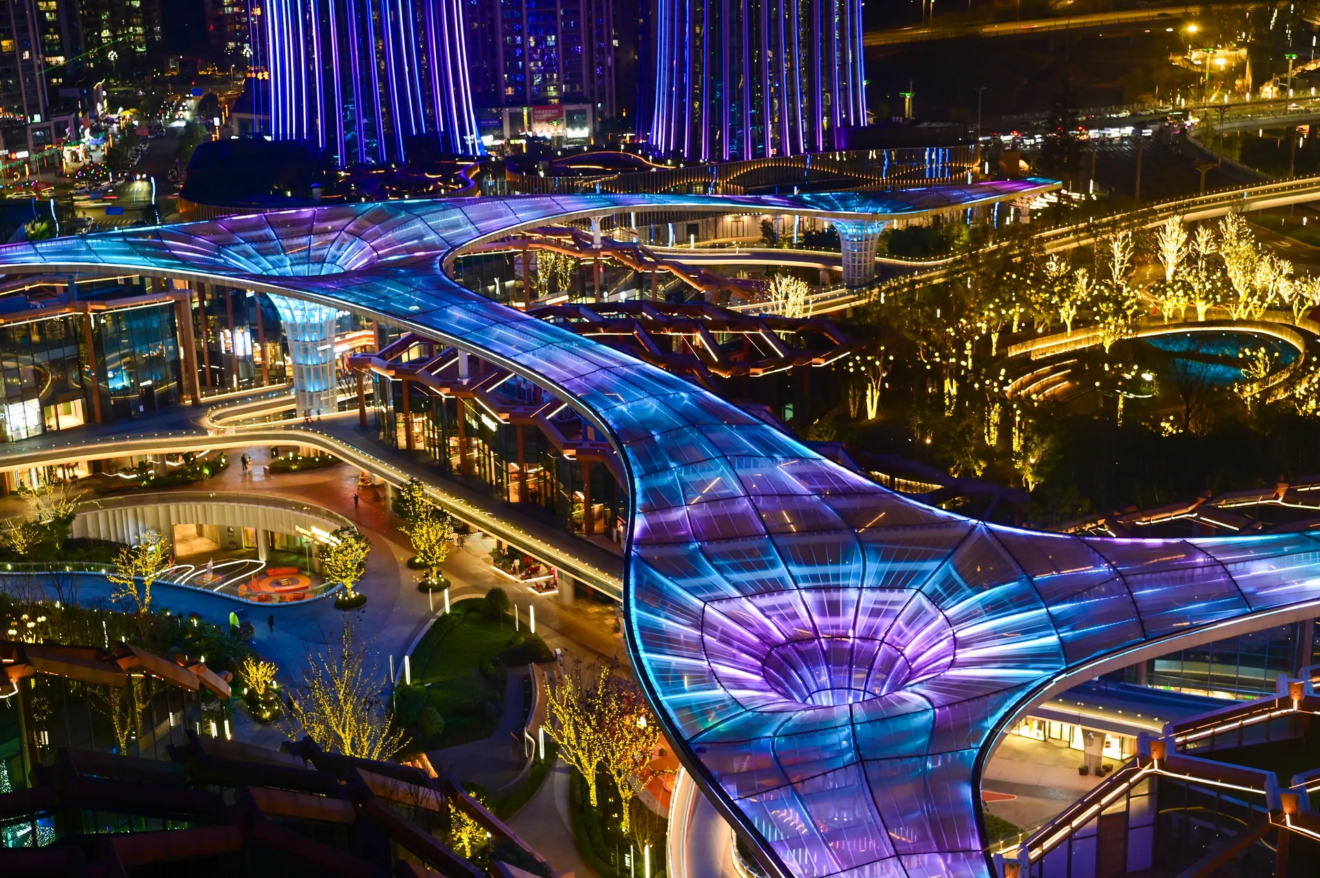A dazzling night view of futuristic architectural design with glowing lights.