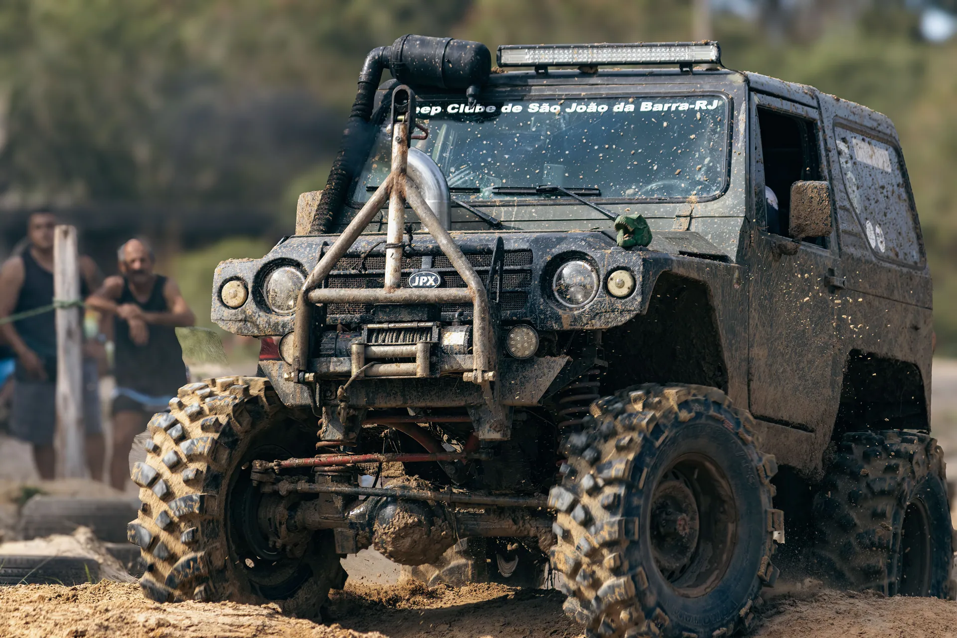A rugged off-road jeep conquering muddy terrain during a thrilling rally event.