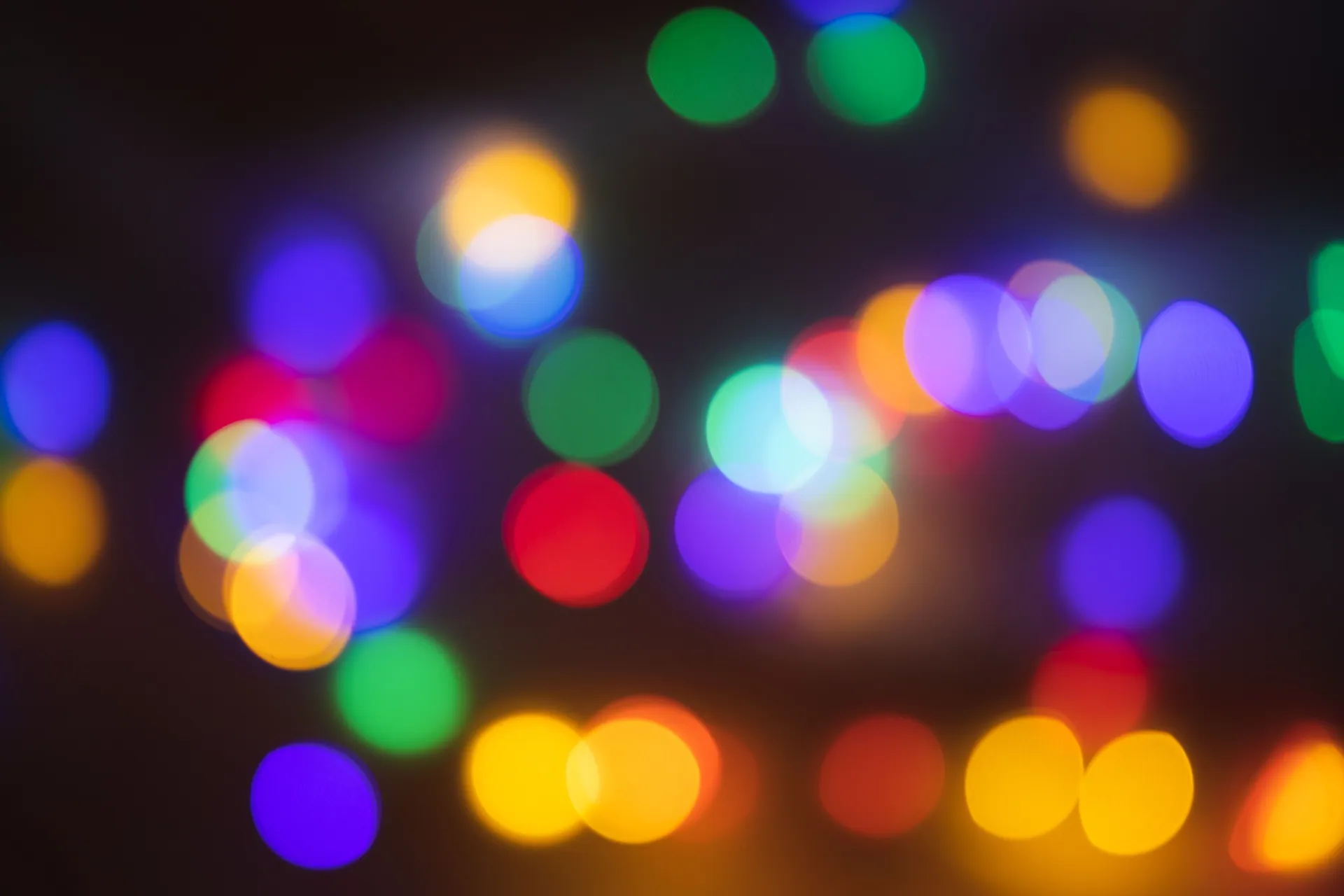 Colorful bokeh lights creating a vibrant abstract background with defocused illumination.