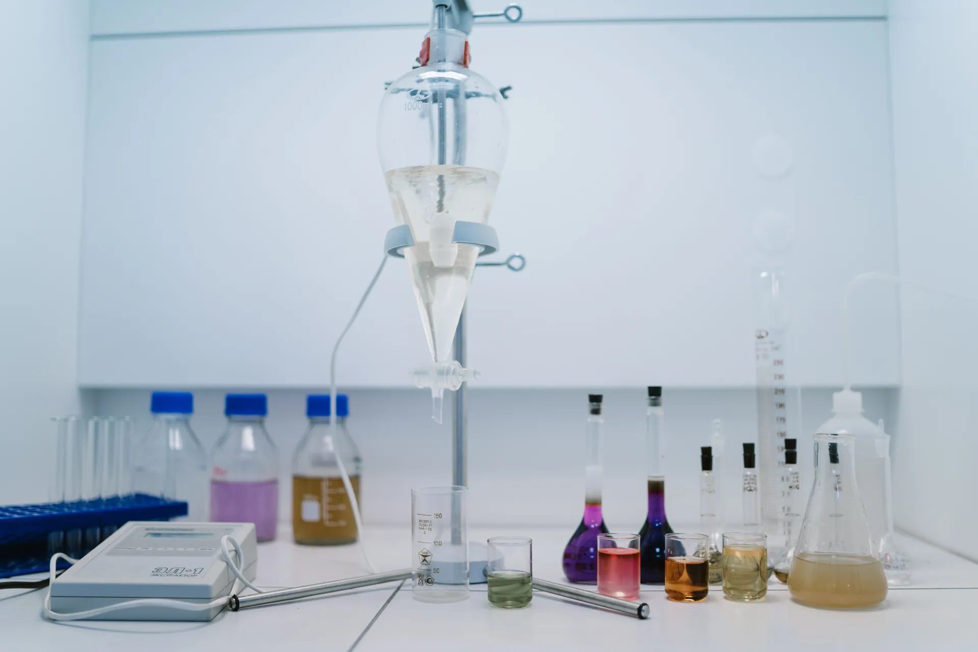 A detailed view of laboratory glassware with colorful chemicals, ideal for scientific research and experiments.