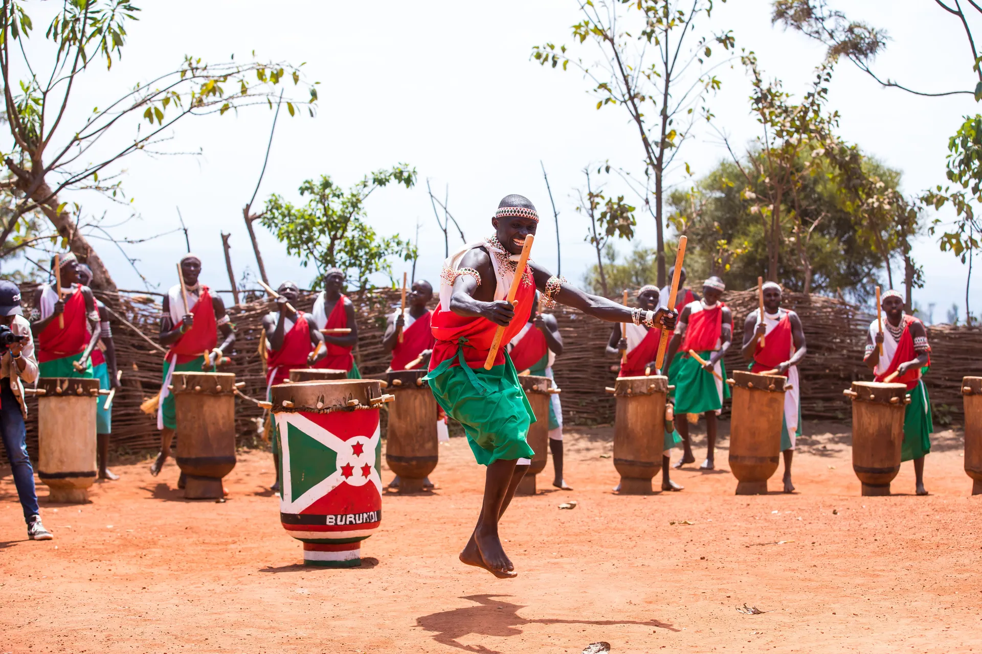 Vibrant outdoor performance by traditional Burundian drummers in cultural attire, celebrating heritage.
