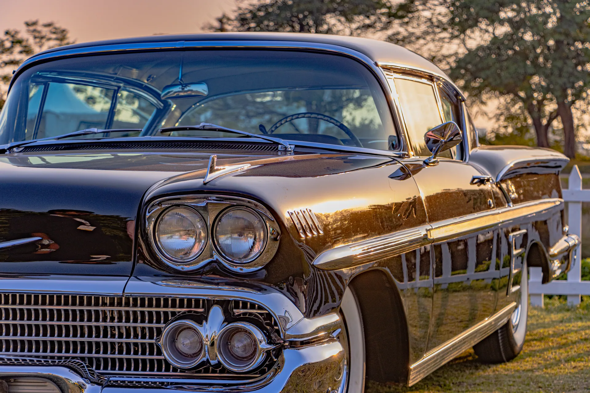 Close-up of a classic 1958 Chevrolet Impala at sunset, outdoors in Gurugram, with a vintage vibe.