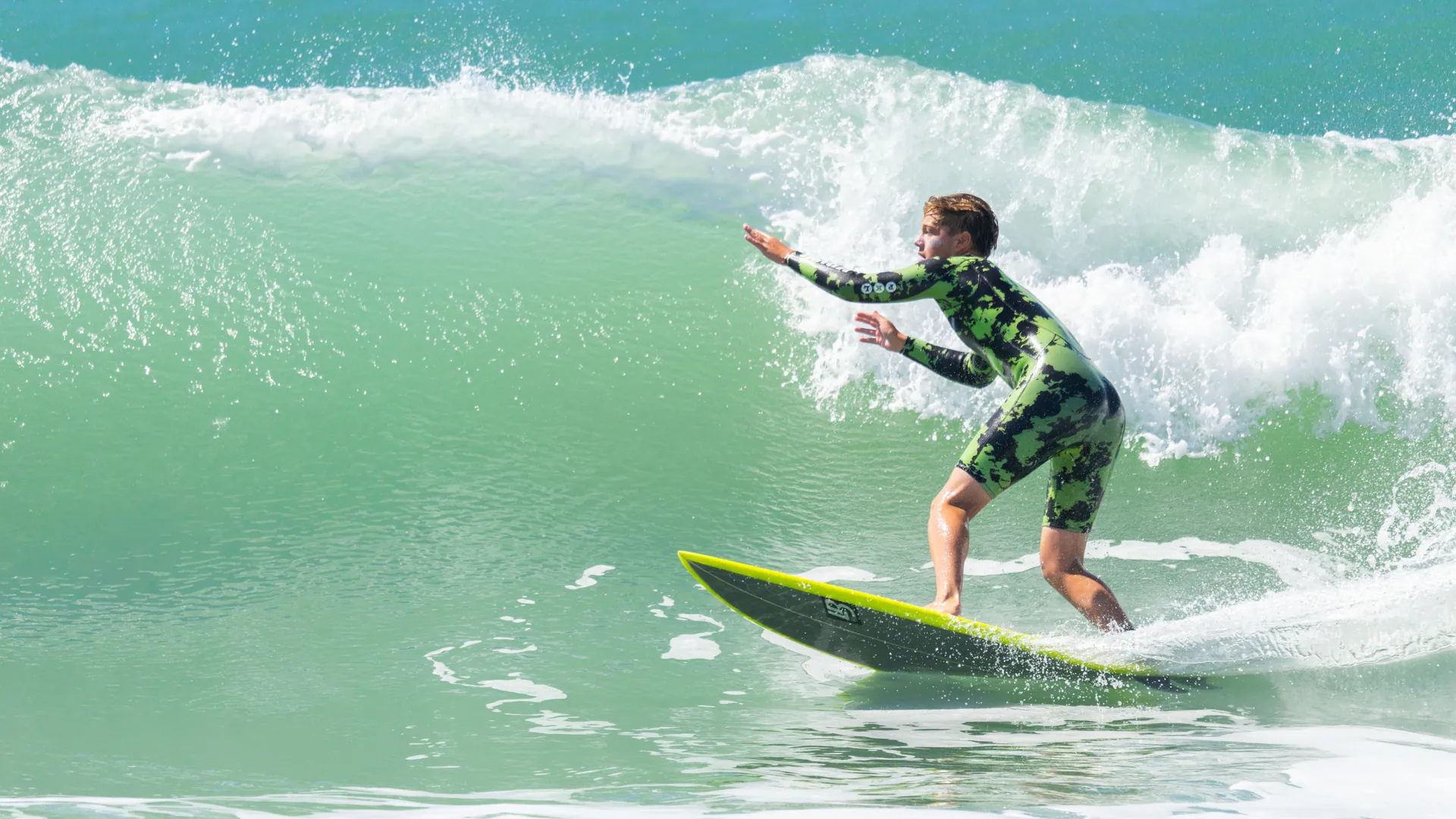 Surfer riding a wave on a sunny day, showcasing skill and adventure.