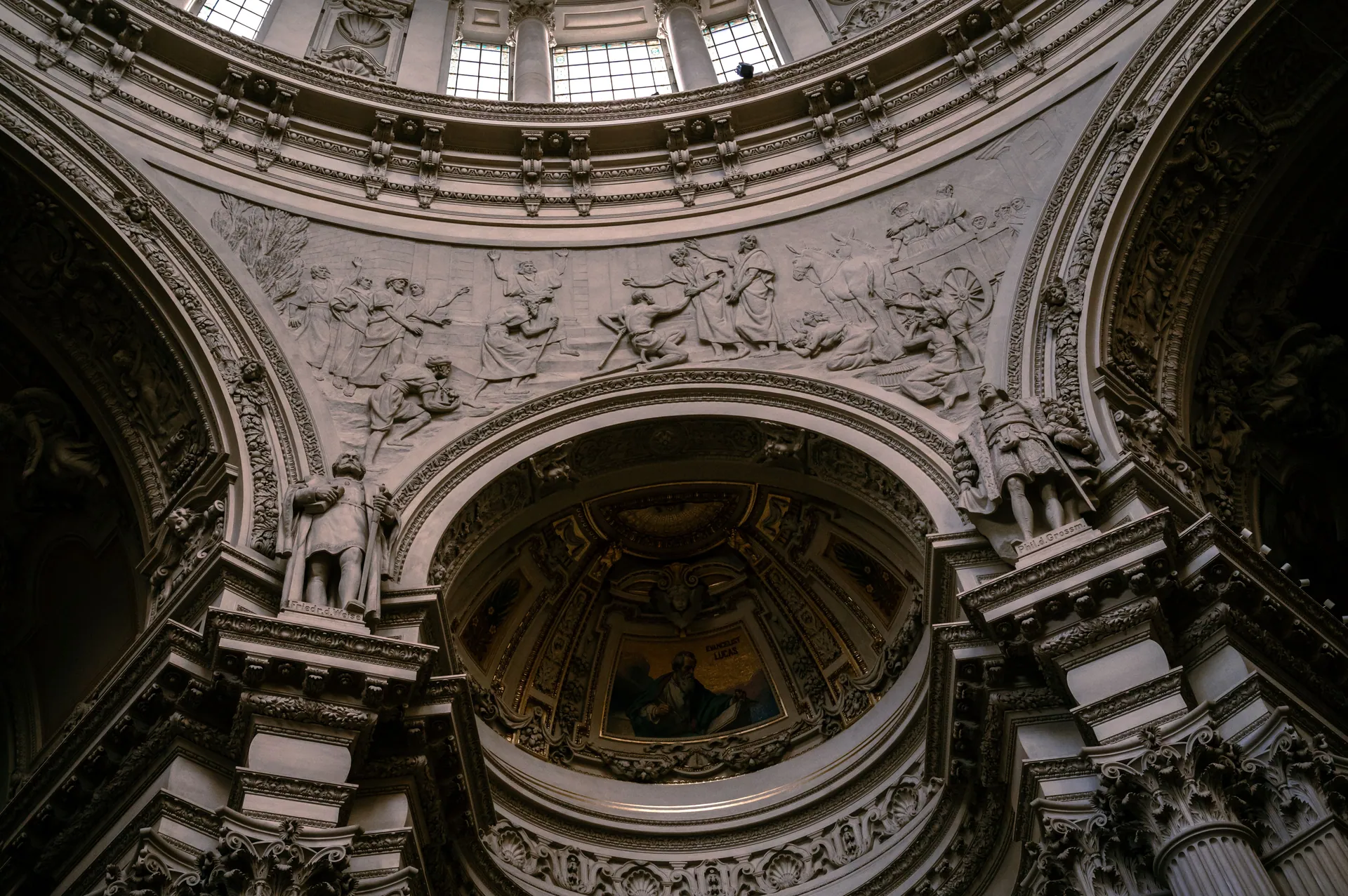 Stunning view of a richly decorated Baroque ceiling with sculptures and detailed ornamentation.