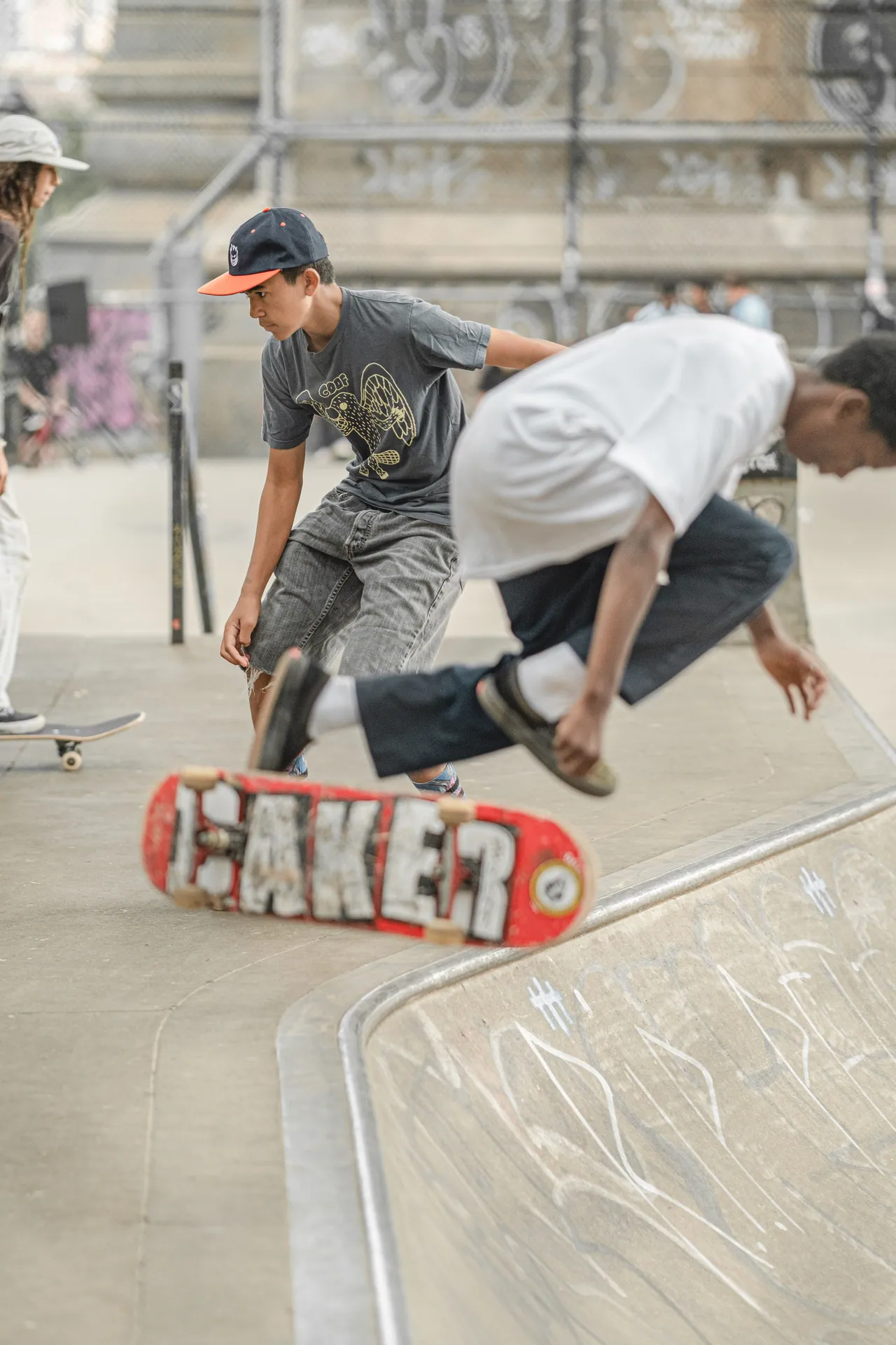 Energetic teenagers skateboarding and performing tricks in New York City's vibrant skate park.
