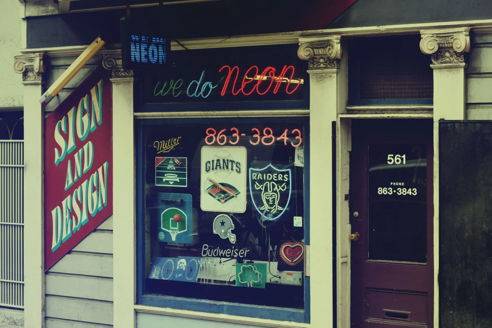 A vibrant neon sign shop front with classic designs in San Francisco's Mission District.