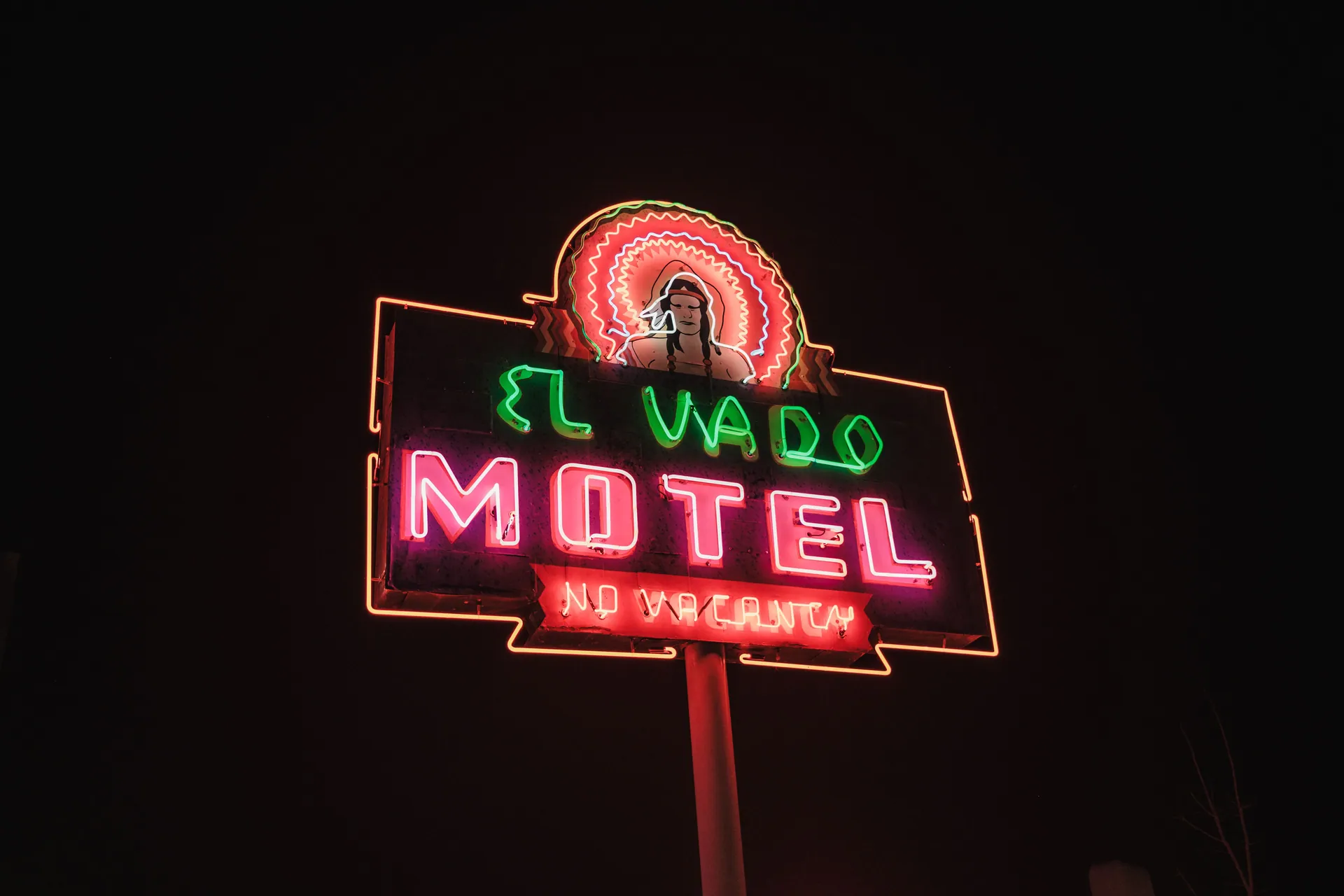 El Vado Motel neon sign glowing brightly in the night sky, showcasing vintage allure.