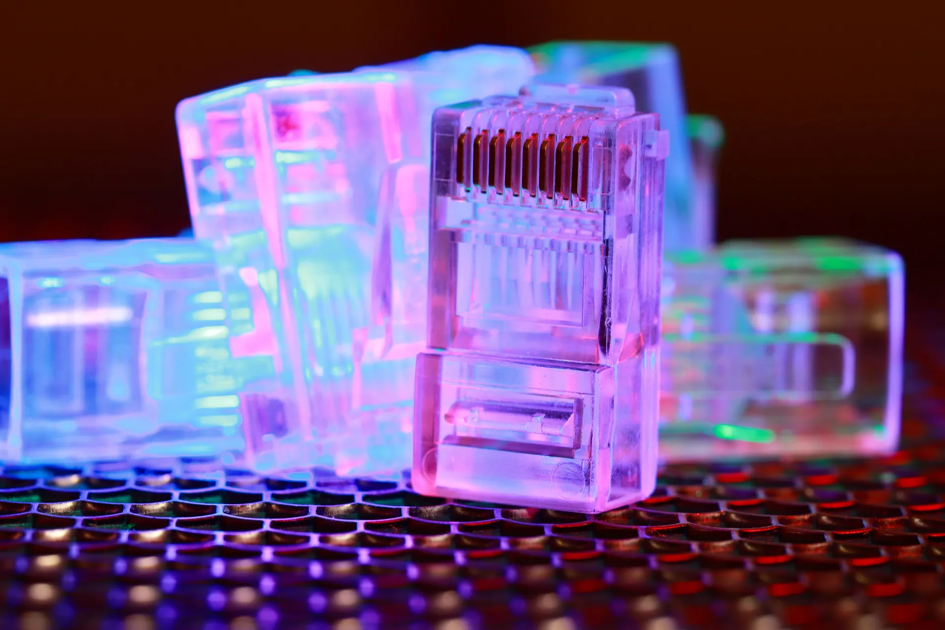 Vibrant close-up of network cable connectors with colorful lighting.