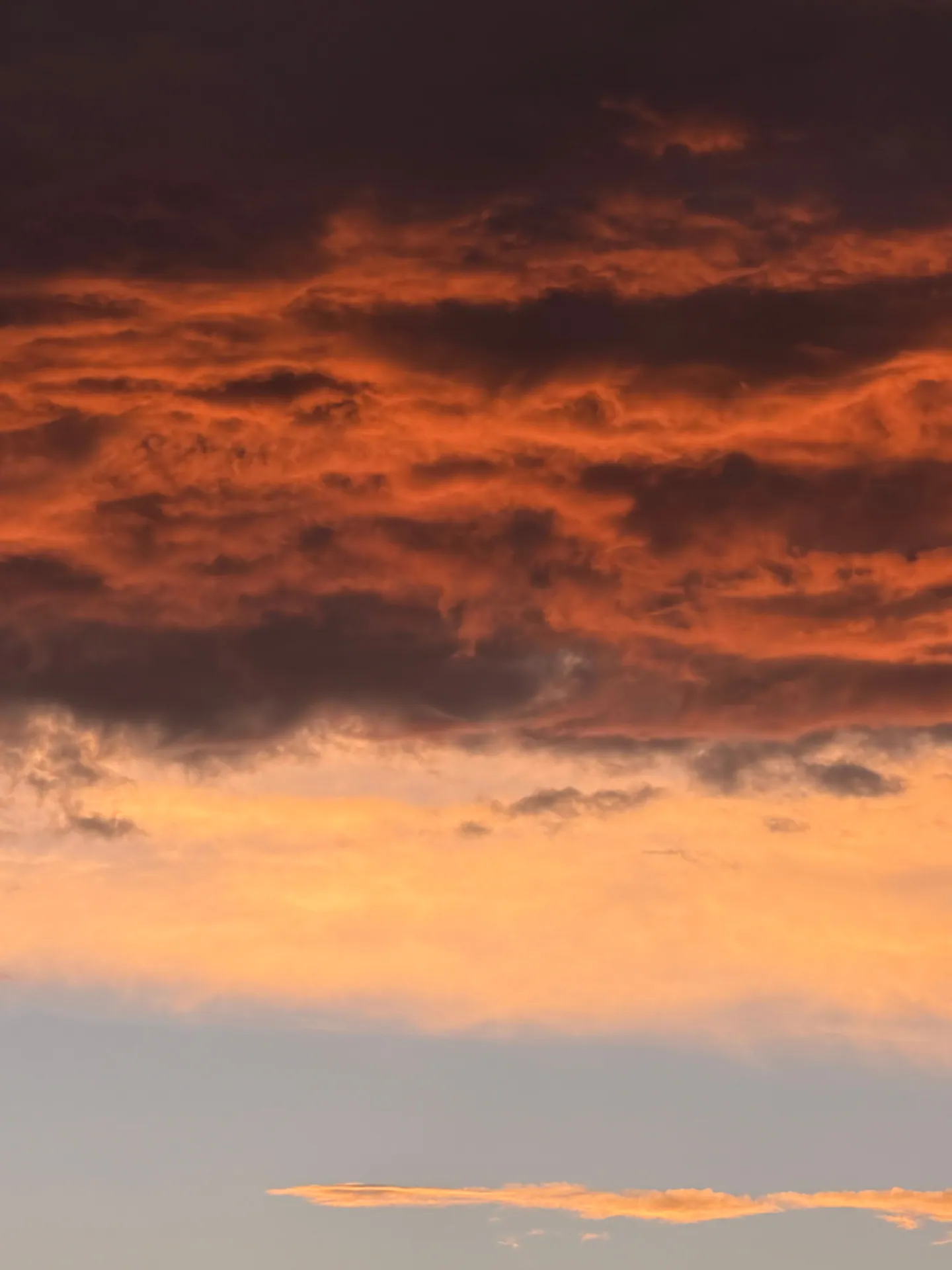 Vivid sunset with dramatic clouds in vibrant orange and pink tones.
