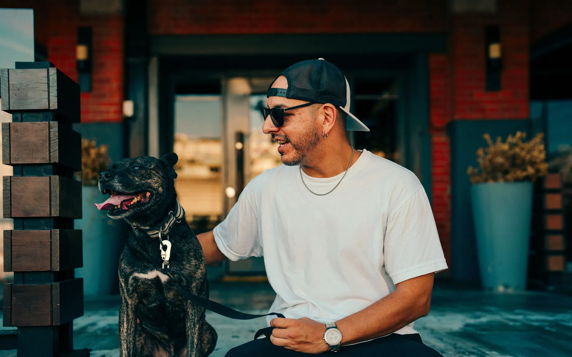 Casual urban scene of a man with dog in Buenos Aires, showcasing street fashion and lifestyle.