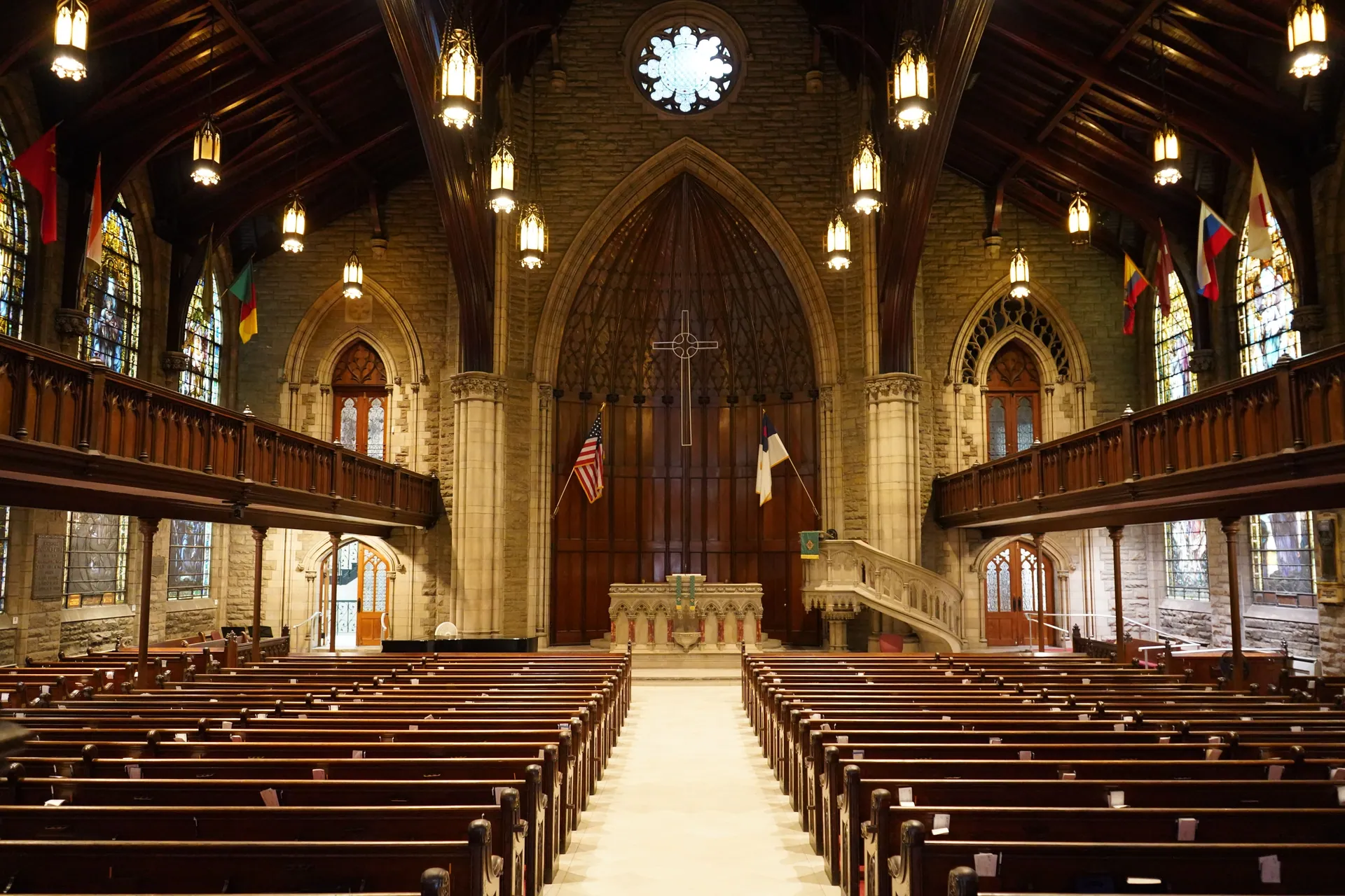 A captivating view of a historic Gothic church interior with wooden pews, stained glass windows, and high ceilings.